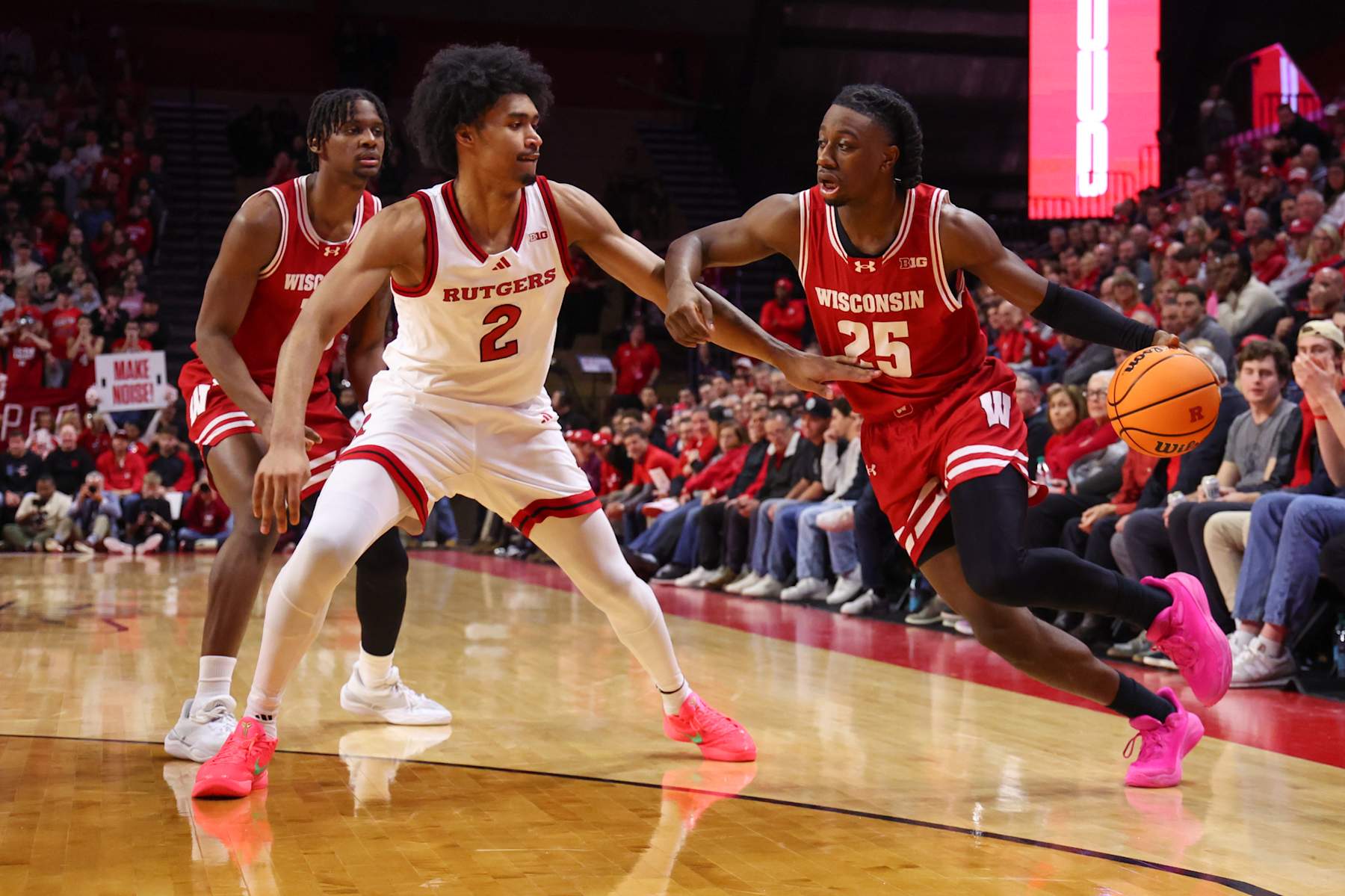 PISCATAWAY, NEW JERSEY - JANUARY 6: John Blackwell #25 of the Wisconsin Badgers dribbles the ball while being defended by Dylan Harper #2 of the Rutgers Scarlet Knights during the first half at Jersey Mike's Arena on January 6, 2025 in Piscataway, New Jersey. (Photo by Ed Mulholland/Getty Images)