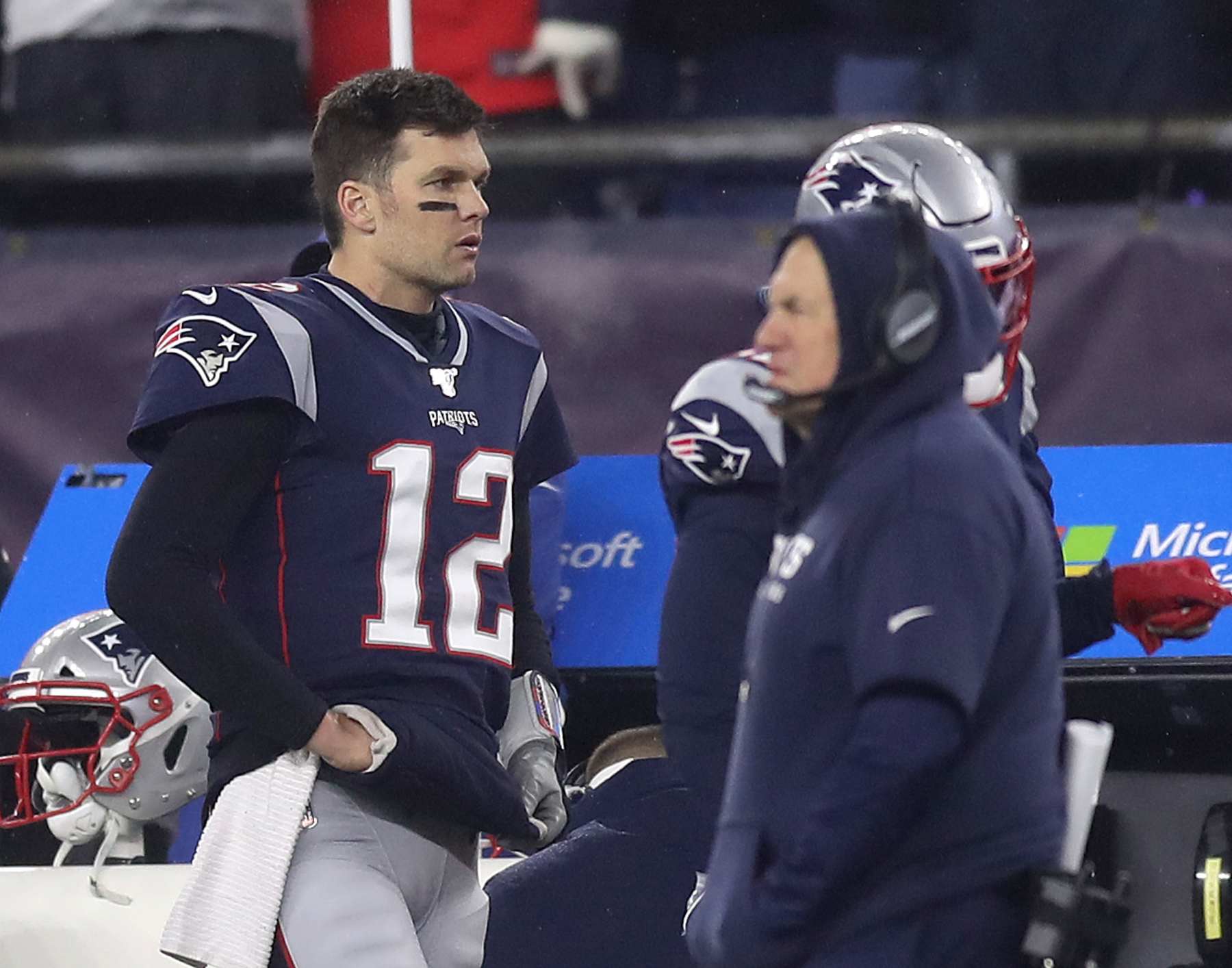FOXBOROUGH, MA - JANUARY 4: New England Patriots quarterback Tom Brady (12) and head coach Bill Belichick stand on the sidelines during the fourth quarter. The New England Patriots host the Tennessee Titans in the Wild Card AFC Division game at Gillette Stadium in Foxborough, MA on Jan. 4, 2020. (Photo by John Tlumacki/The Boston Globe via Getty Images)