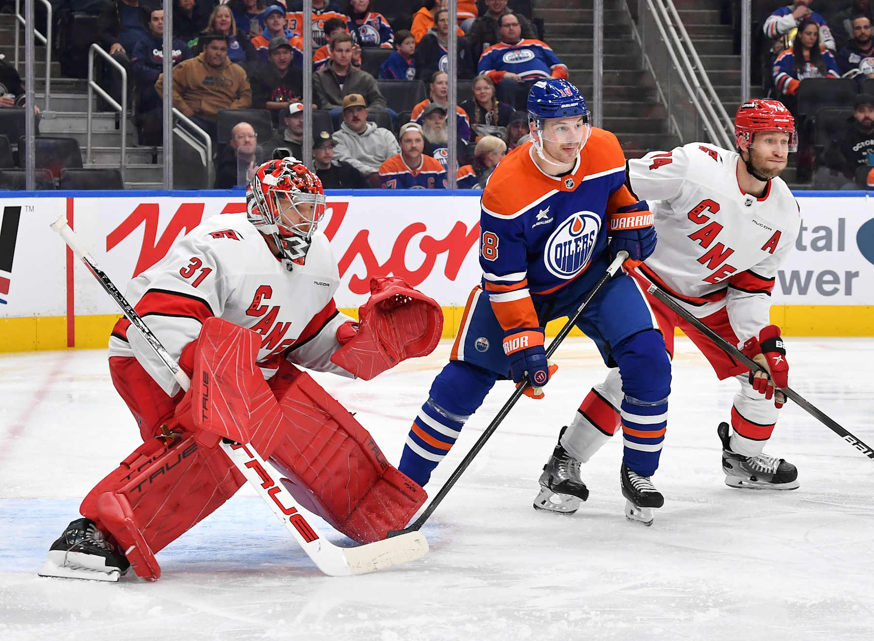 EDMONTON, CANADA - OCTOBER 22: Zach Hyman #18 of the Edmonton Oilers battles for position against Jaccob Slavin #74 of the Carolina Hurricanes as Frederik Andersen #31 tracks the puck during the second period of the game at Rogers Place on October 22, 2024, in Edmonton, Alberta, Canada. (Photo by Andy Devlin/NHLI via Getty Images)