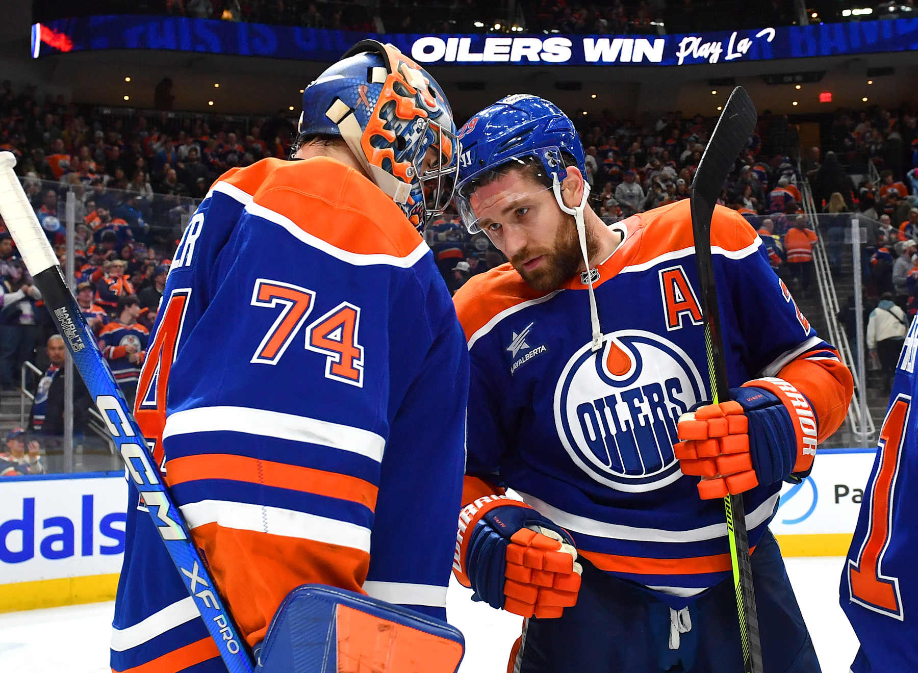EDMONTON, CANADA - DECEMBER 31: Leon Draisaitl #29 and Stuart Skinner #74 of the Edmonton Oilers celebrate a victory over the Utah Hockey Club after the game at Rogers Place on December 31, 2024, in Edmonton, Alberta, Canada. (Photo by Andy Devlin/NHLI via Getty Images)