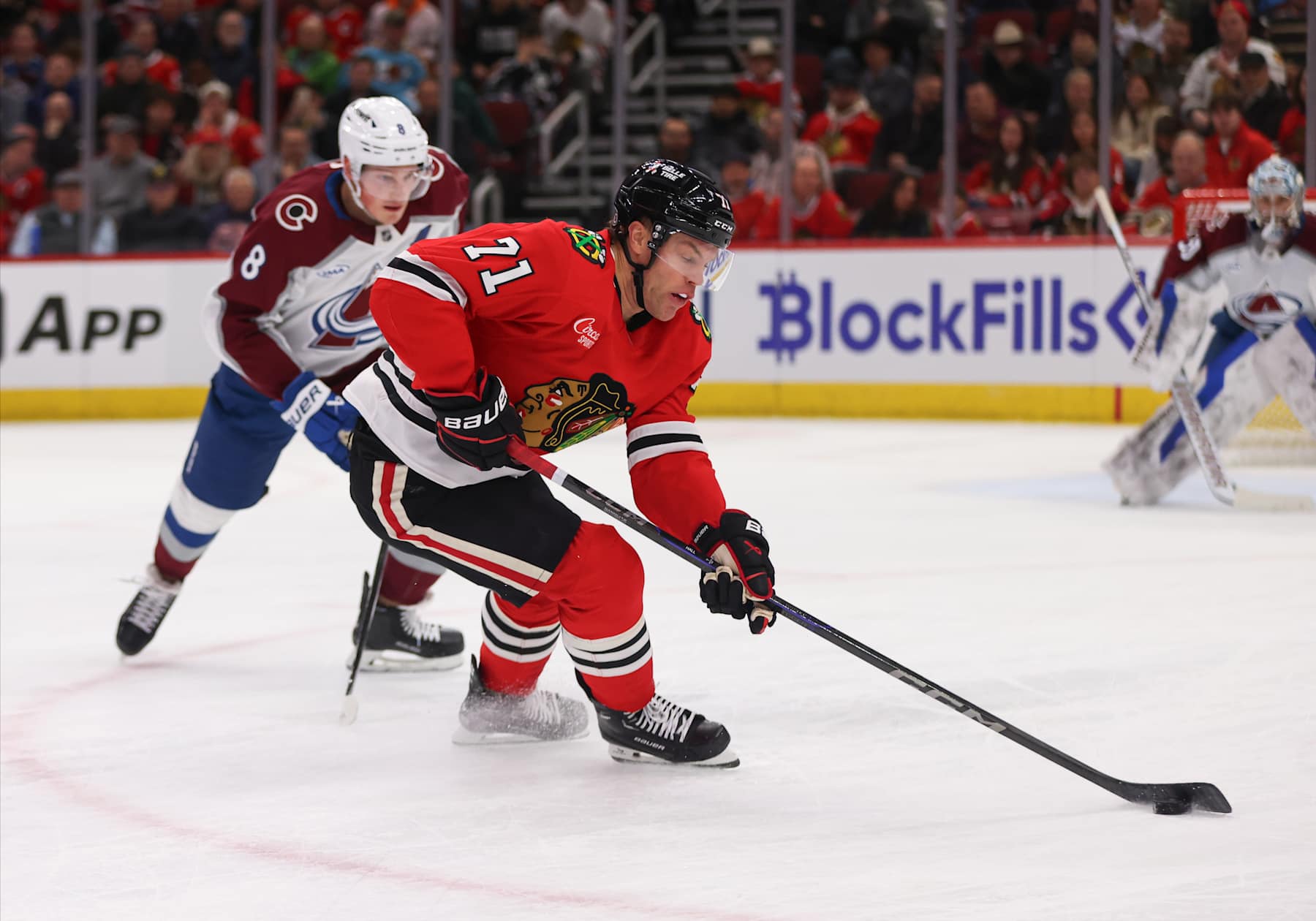 CHICAGO, IL - JANUARY 08: Taylor Hall #71 of the Chicago Blackhawks controls the puck against Cale Makar #8 of the Colorado Avalanche during the first period on January 8, 2024 at the United Center in Chicago, Illinois. (Photo by Melissa Tamez/Icon Sportswire via Getty Images)