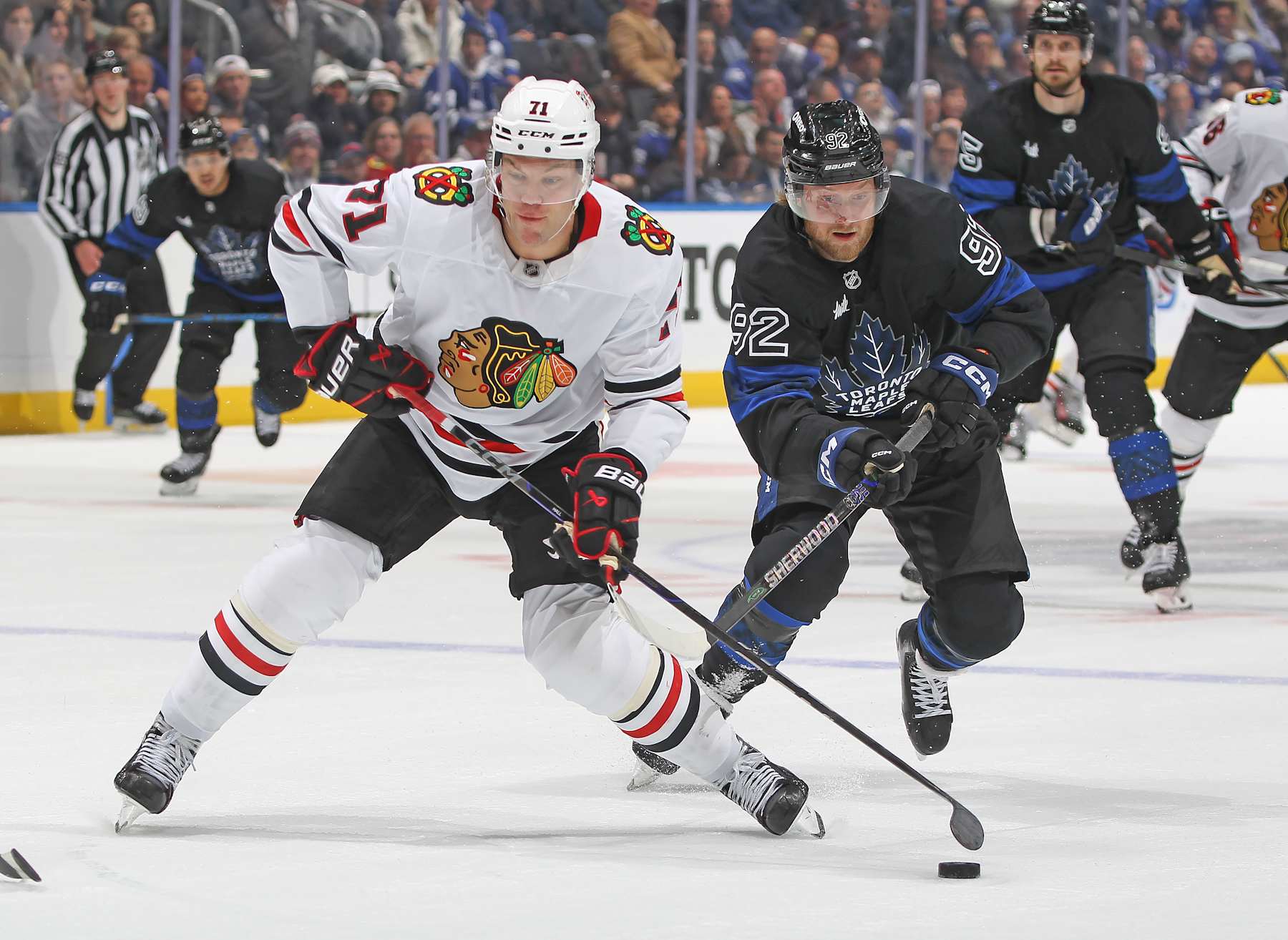 TORONTO, CANADA - DECEMBER 2: Taylor Hall #71 of the Chicago Blackhawks draws a penalty on Alexander Nylander #92 of the Toronto Maple Leafs during the third period of an NHL game at Scotiabank Arena on December 2, 2024 in Toronto, Ontario, Canada. Alexander Nylander was called for a hooking penalty on the play. The Maple Leafs defeated the Blackhawks 4-1. (Photo by Claus Andersen/Getty Images)