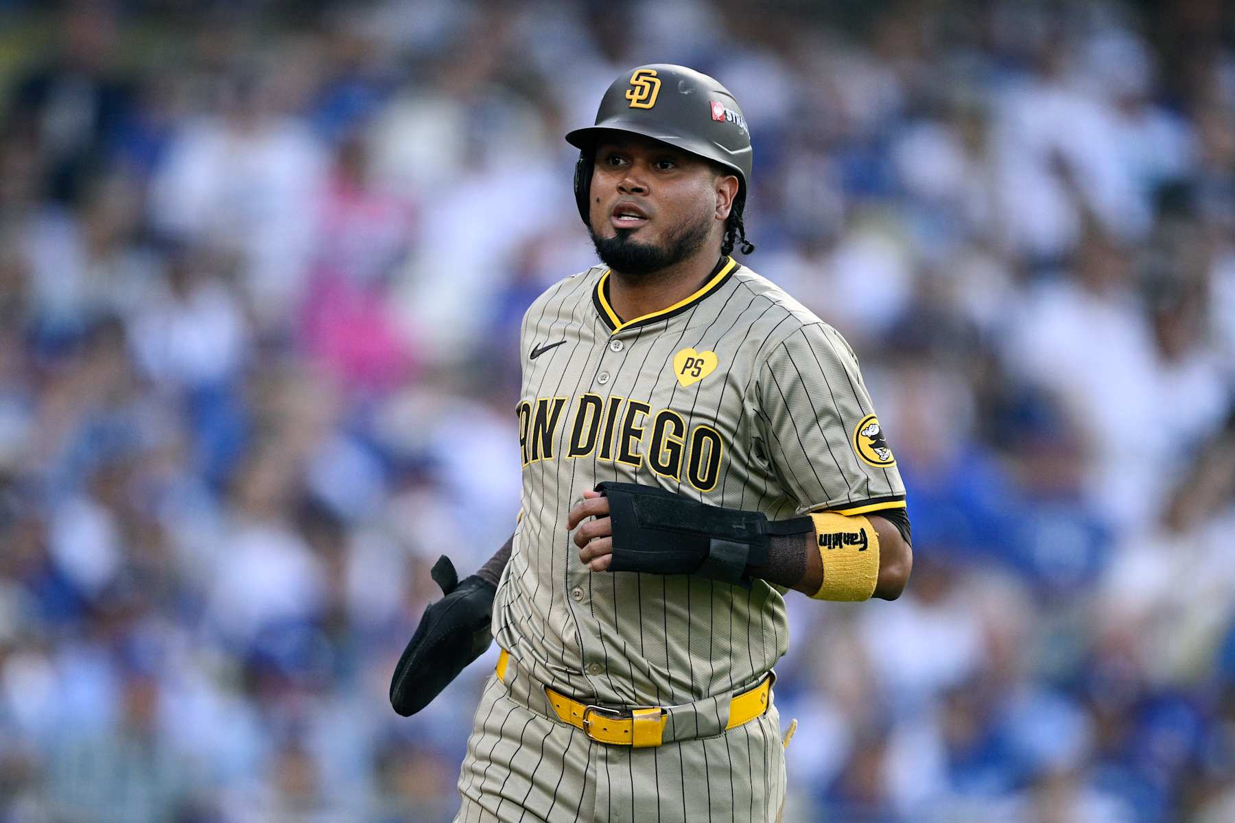 LOS ANGELES, CALIFORNIA - OCTOBER 05: Luis Arraez #4 of the San Diego Padres celebrates after scoring a run during the first inning against the Los Angeles Dodgers in Game One of the Division Series at Dodger Stadium on October 05, 2024 in Los Angeles, California.  (Photo by Orlando Ramirez/Getty Images)