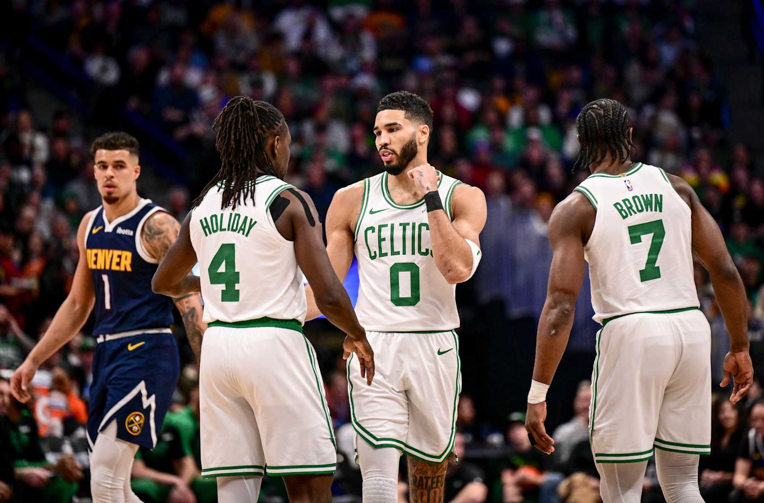 DENVER, CO - JANUARY 7: Jayson Tatum (0) of the Boston Celtics talks to Jrue Holiday (4) and Jaylen Brown (7) as Michael Porter Jr. (1) of the Denver Nuggets looks on during the first quarter at Ball Arena in Denver, Colorado on Tuesday, January 7, 2025. (Photo by AAron Ontiveroz/The Denver Post) DENVER, CO - JANUARY 7: Jayson Tatum (0) of the Boston Celtics talks to Jrue Holiday (4) and Jaylen Brown (7) as Michael Porter Jr. (1) of the Denver Nuggets looks on during the first quarter at Ball Arena in Denver, Colorado on Tuesday, January 7, 2025. (Photo by AAron Ontiveroz/The Denver Post)