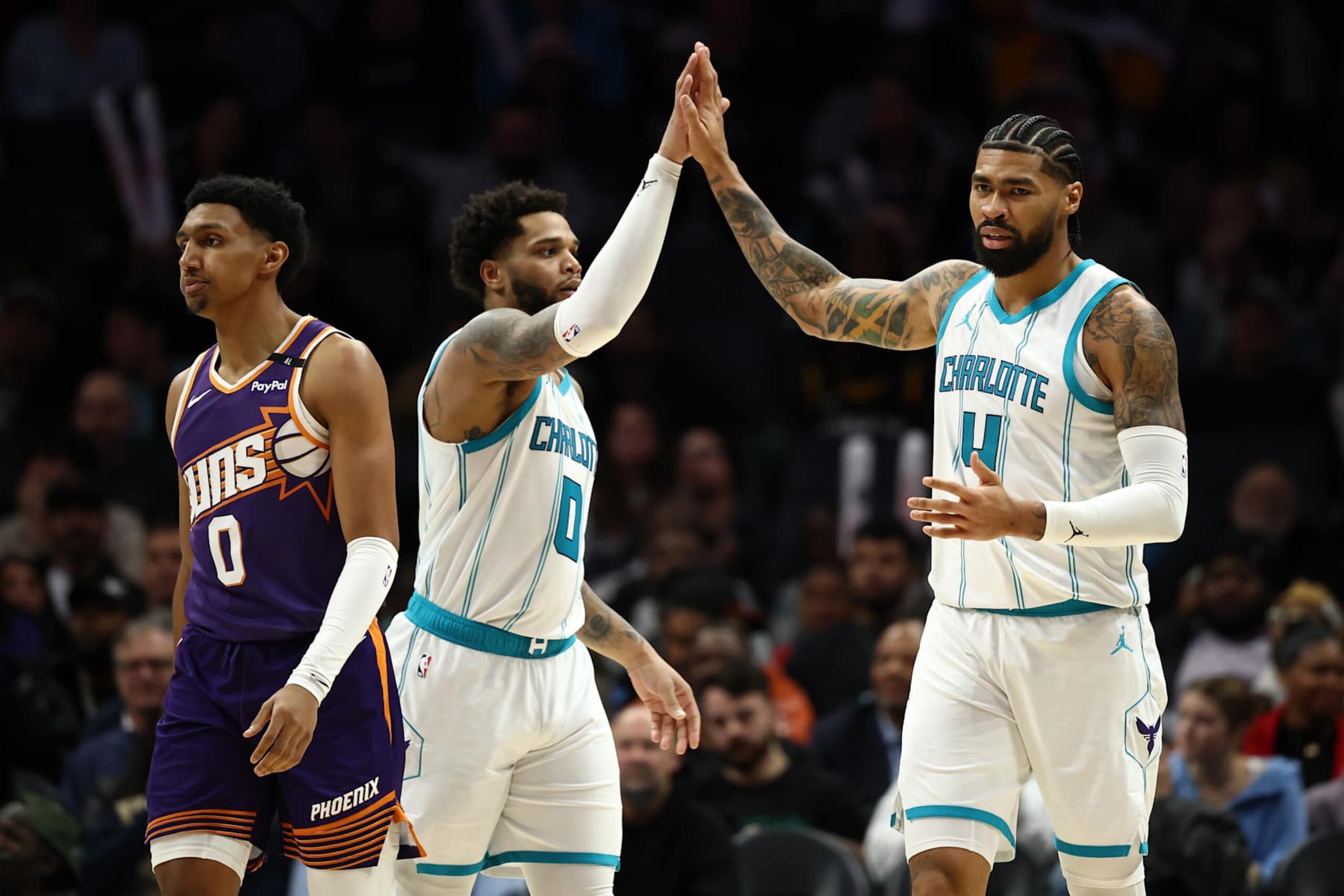CHARLOTTE, NORTH CAROLINA - JANUARY 07: Nick Richards #4 of the Charlotte Hornets reacts with teammate Miles Bridges #0 during the second half of the game against the Phoenix Suns at Spectrum Center on January 07, 2025 in Charlotte, North Carolina. NOTE TO USER: User expressly acknowledges and agrees that, by downloading and or using this photograph, User is consenting to the terms and conditions of the Getty Images License Agreement. (Photo by Jared C. Tilton/Getty Images) CHARLOTTE, NORTH CAROLINA - JANUARY 07: Nick Richards #4 of the Charlotte Hornets reacts with teammate Miles Bridges #0 during the second half of the game against the Phoenix Suns at Spectrum Center on January 07, 2025 in Charlotte, North Carolina. NOTE TO USER: User expressly acknowledges and agrees that, by downloading and or using this photograph, User is consenting to the terms and conditions of the Getty Images License Agreement. (Photo by Jared C. Tilton/Getty Images)