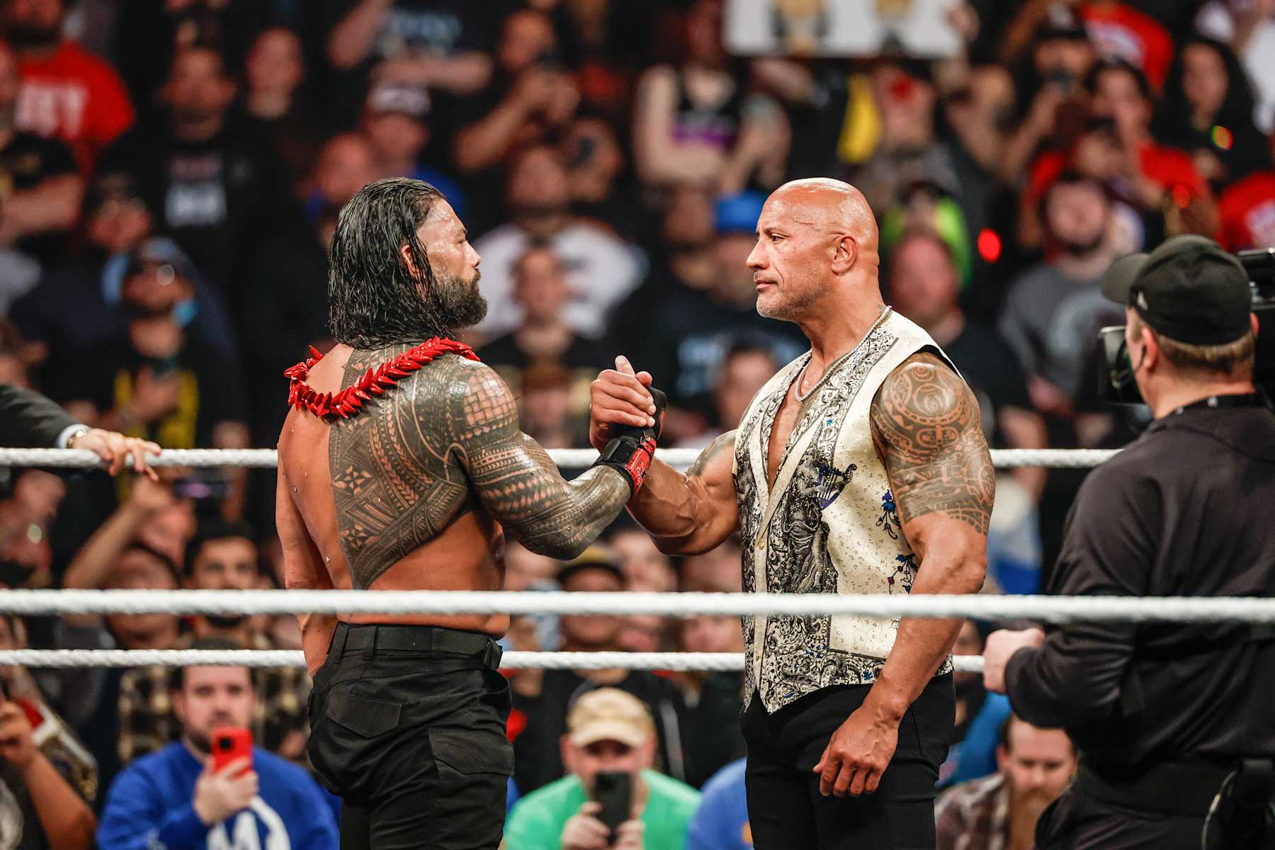 INGLEWOOD, CALIFORNIA - JANUARY 6: Roman Reigns and Dwayne "The Rock" Johnson embrace during RAW at Intuit Dome on January 6, 2025 in Inglewood, California. (Photo by WWE/Getty Images)