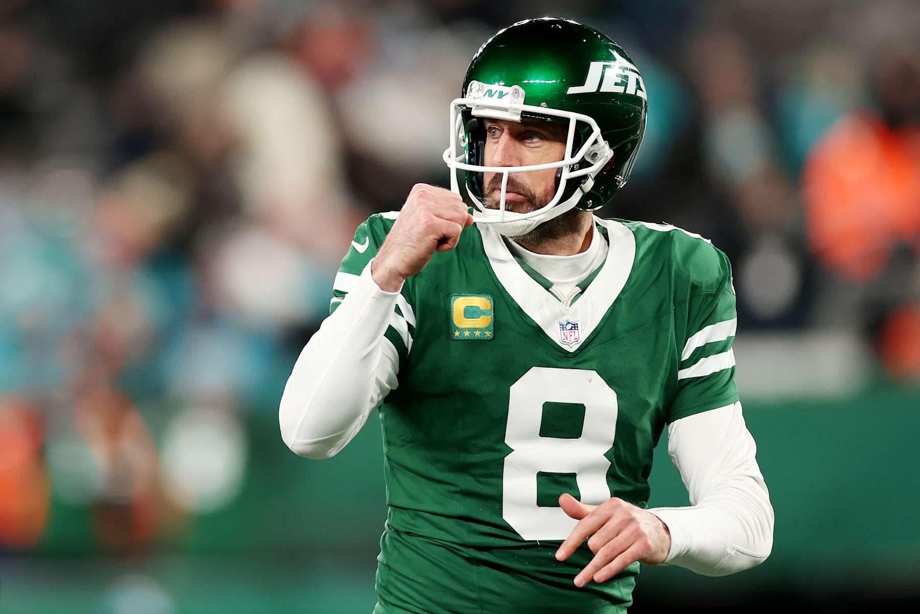 EAST RUTHERFORD, NEW JERSEY - JANUARY 05: Aaron Rodgers #8 of the New York Jets reacts after a touchdown against the Miami Dolphins during the fourth quarter at MetLife Stadium on January 05, 2025 in East Rutherford, New Jersey. (Photo by Luke Hales/Getty Images)
