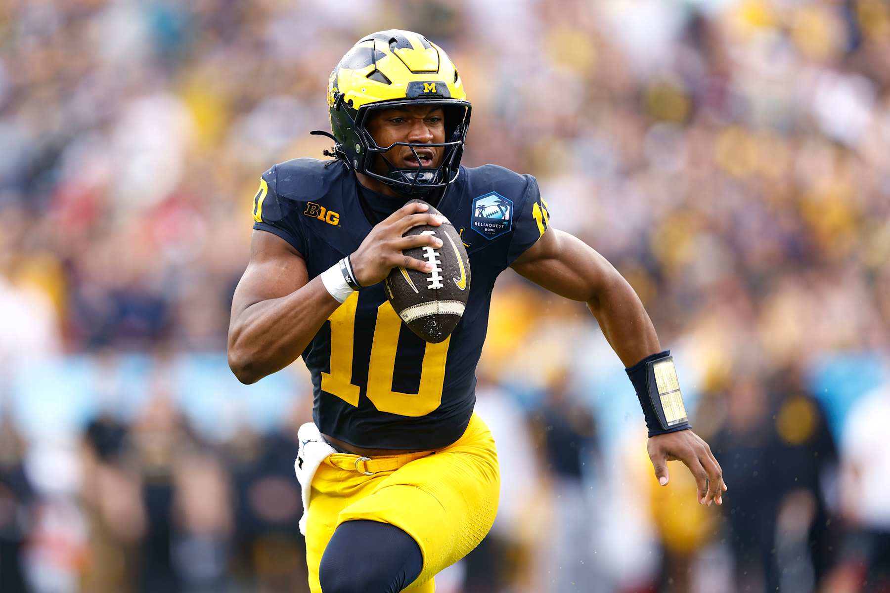 TAMPA, FLORIDA - DECEMBER 31: Alex Orji #10 of the Michigan Wolverines runs with the ball during the first quarter against the Alabama Crimson Tide in the 2024 ReliaQuest Bowl at Raymond James Stadium on December 31, 2024 in Tampa, Florida. (Photo by Douglas P. DeFelice/Getty Images)