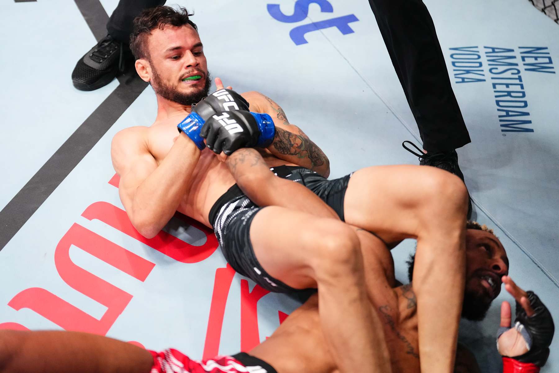LAS VEGAS, NEVADA - JANUARY 11: (L-R) Felipe Bunes of Brazil secures an arm bar submission against Jose Johnson in a flyweight fight during the UFC Fight Night event at UFC APEX on January 11, 2025 in Las Vegas, Nevada. (Photo by Chris Unger/Zuffa LLC via Getty Images)