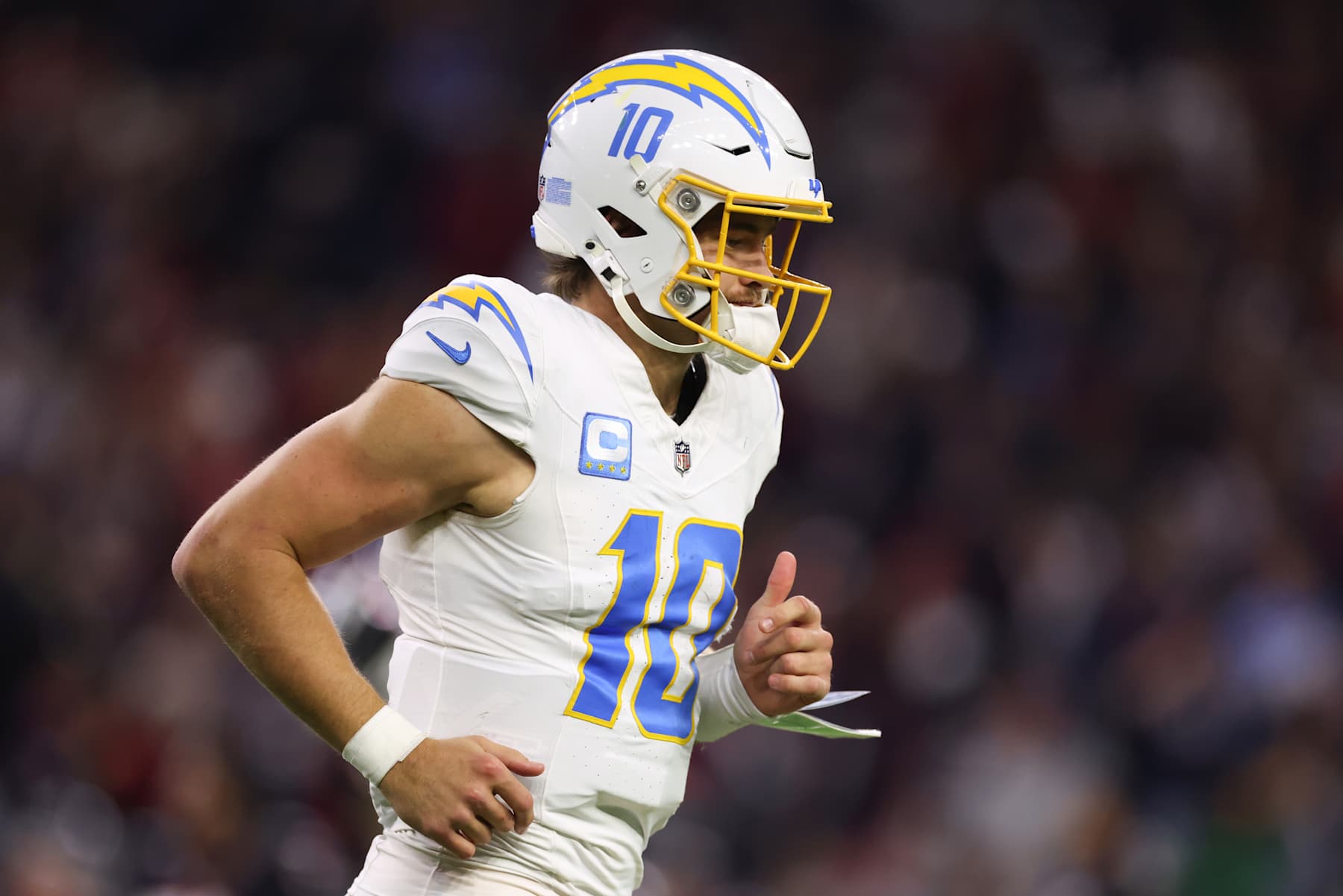 HOUSTON, TEXAS - JANUARY 11: Justin Herbert #10 of the Los Angeles Chargers reacts after throwing an interception against the Houston Texans in the third quarter during the AFC Wild Card Playoffs at NRG Stadium on January 11, 2025 in Houston, Texas. (Photo by Tim Warner/Getty Images)