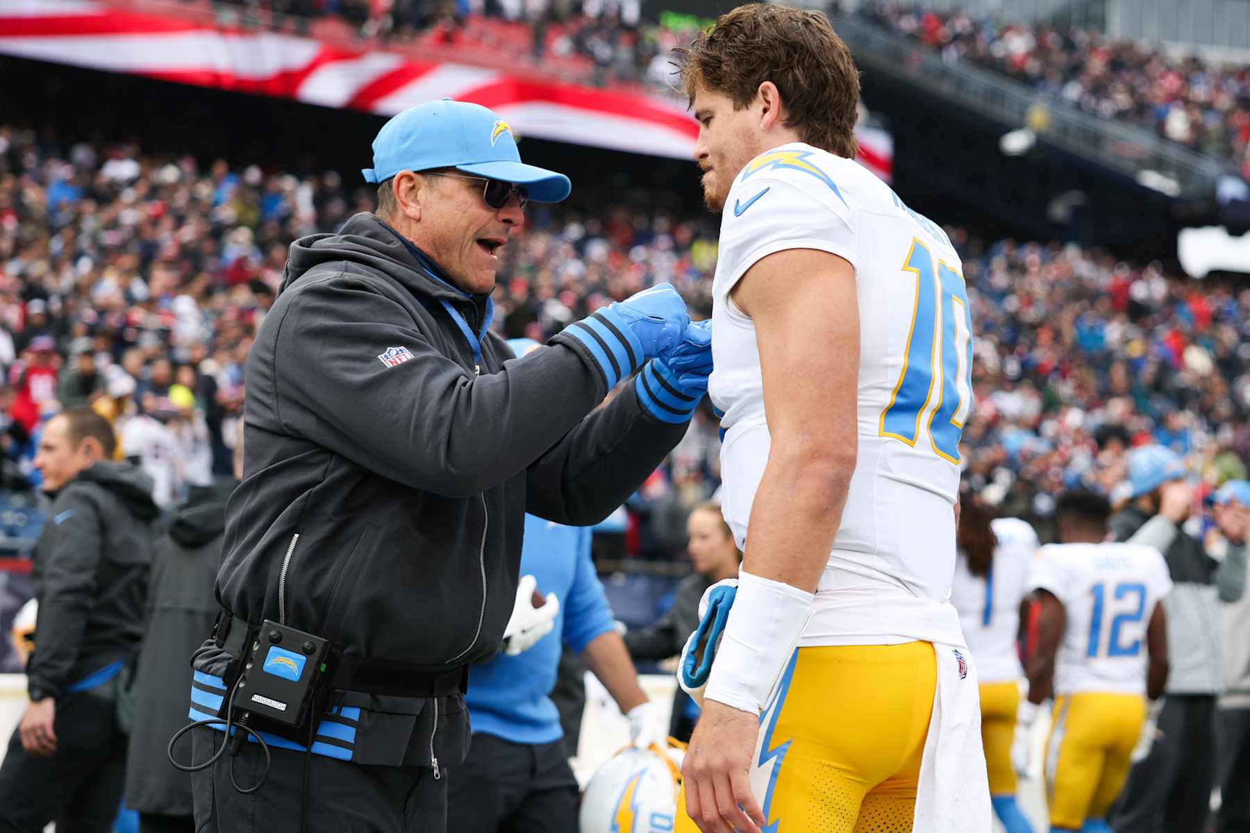 FOXBOROUGH, MASSACHUSETTS - DECEMBER 28: Jim Harbaugh head coach of the Los Angeles Chargers pumps up Justin Herbert #10 of the Los Angeles Chargers prior to the start of the game against the New England Patriots at Gillette Stadium on December 28, 2024 in Foxborough, Massachusetts. (Photo by Kathryn Riley/Getty Images)