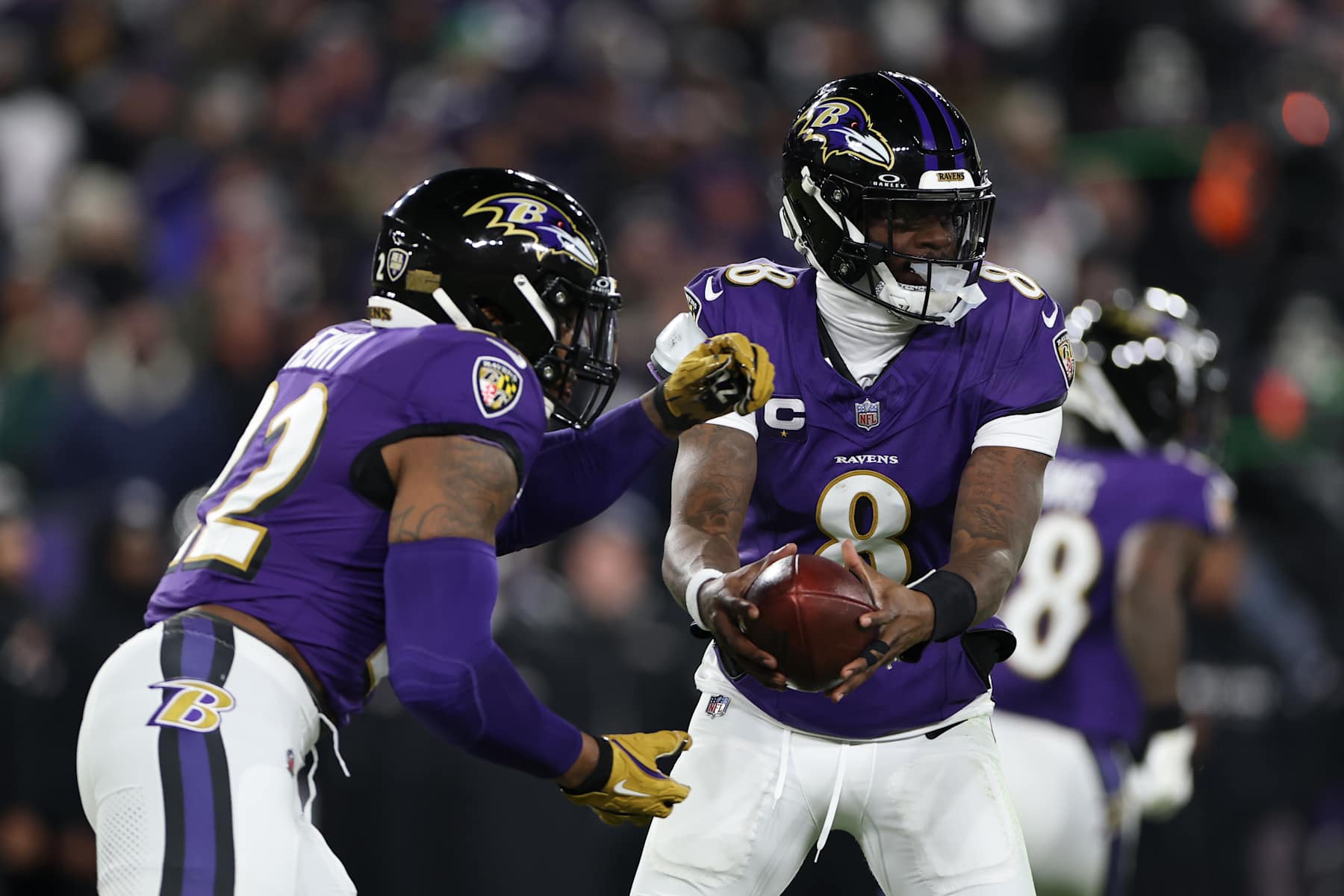 BALTIMORE, MARYLAND - JANUARY 11: Lamar Jackson #8 of the Baltimore Ravens hands the ball off to Derrick Henry #22 during the first quarter against the Pittsburgh Steelers during the AFC Wild Card Playoff at M&T Bank Stadium on January 11, 2025 in Baltimore, Maryland. (Photo by Scott Taetsch/Getty Images)