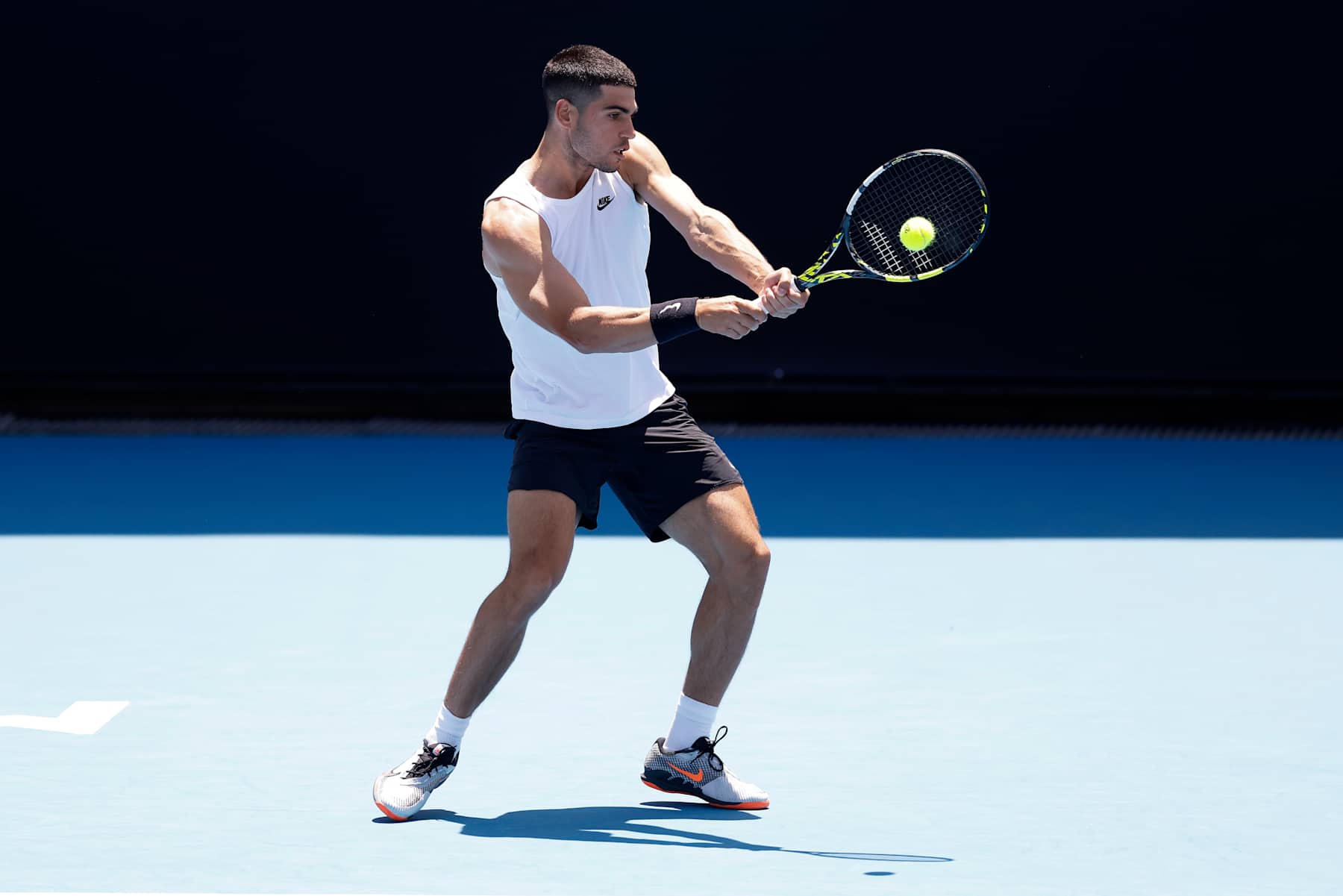 MELBOURNE, AUSTRALIA - JANUARY 10: Carlos Alcaraz of Spain plays a backhand during a practice session ahead of the 2025 Australian Open at Melbourne Park on January 10, 2025 in Melbourne, Australia. (Photo by Daniel Pockett/Getty Images)