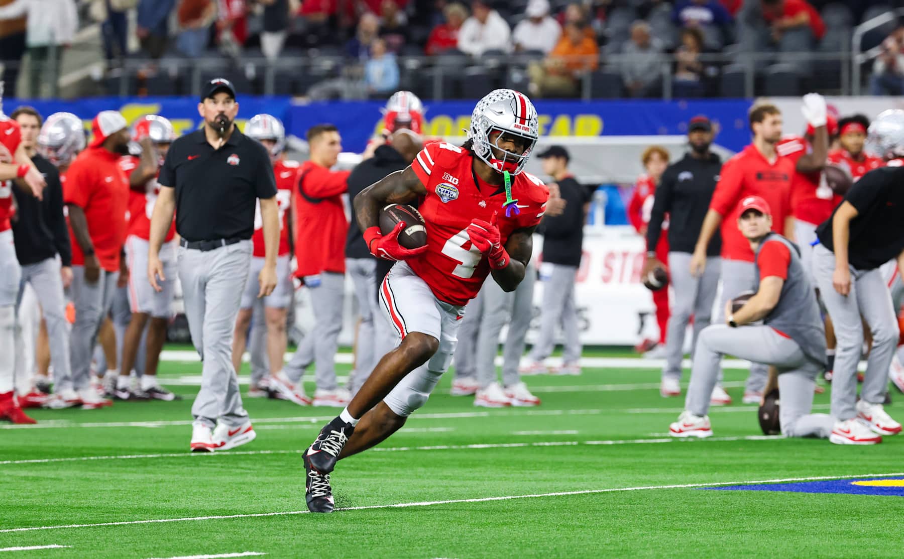 ARLINGTON, TEXAS - JANUARY 10: Jeremiah Smith #4 of the Ohio State Buckeyes warms up before the game against the Texas Longhorns during the Goodyear Cotton Bowl at AT&T Stadium on January 10, 2025 in Arlington, Texas. (Photo by CFP/Getty Images)