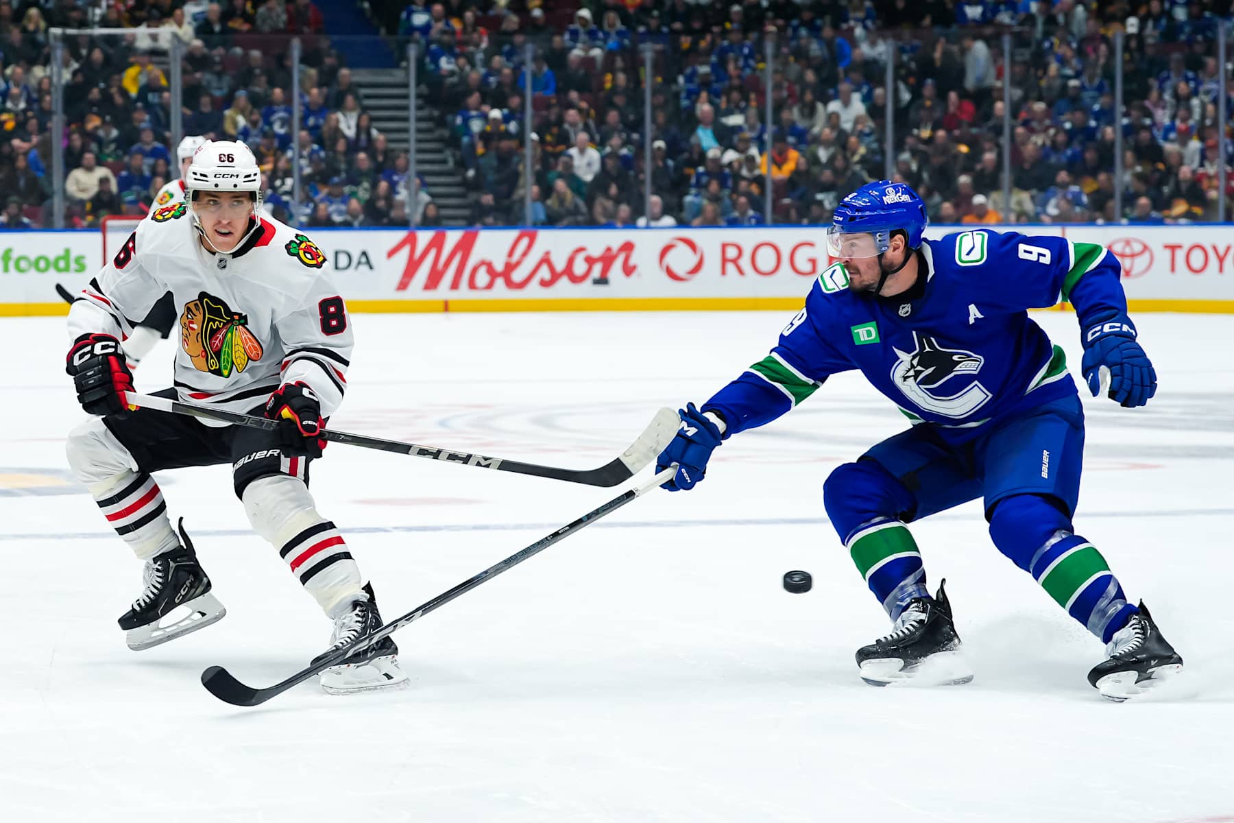 VANCOUVER, CANADA - NOVEMBER 16: J.T. Miller #9 of the Vancouver Canucks defends against Teuvo Teravainen #86 of the Chicago Blackhawks during the third period of their NHL game at Rogers Arena on November 16, 2024 in Vancouver, British Columbia, Canada. (Photo by Derek Cain/Getty Images)