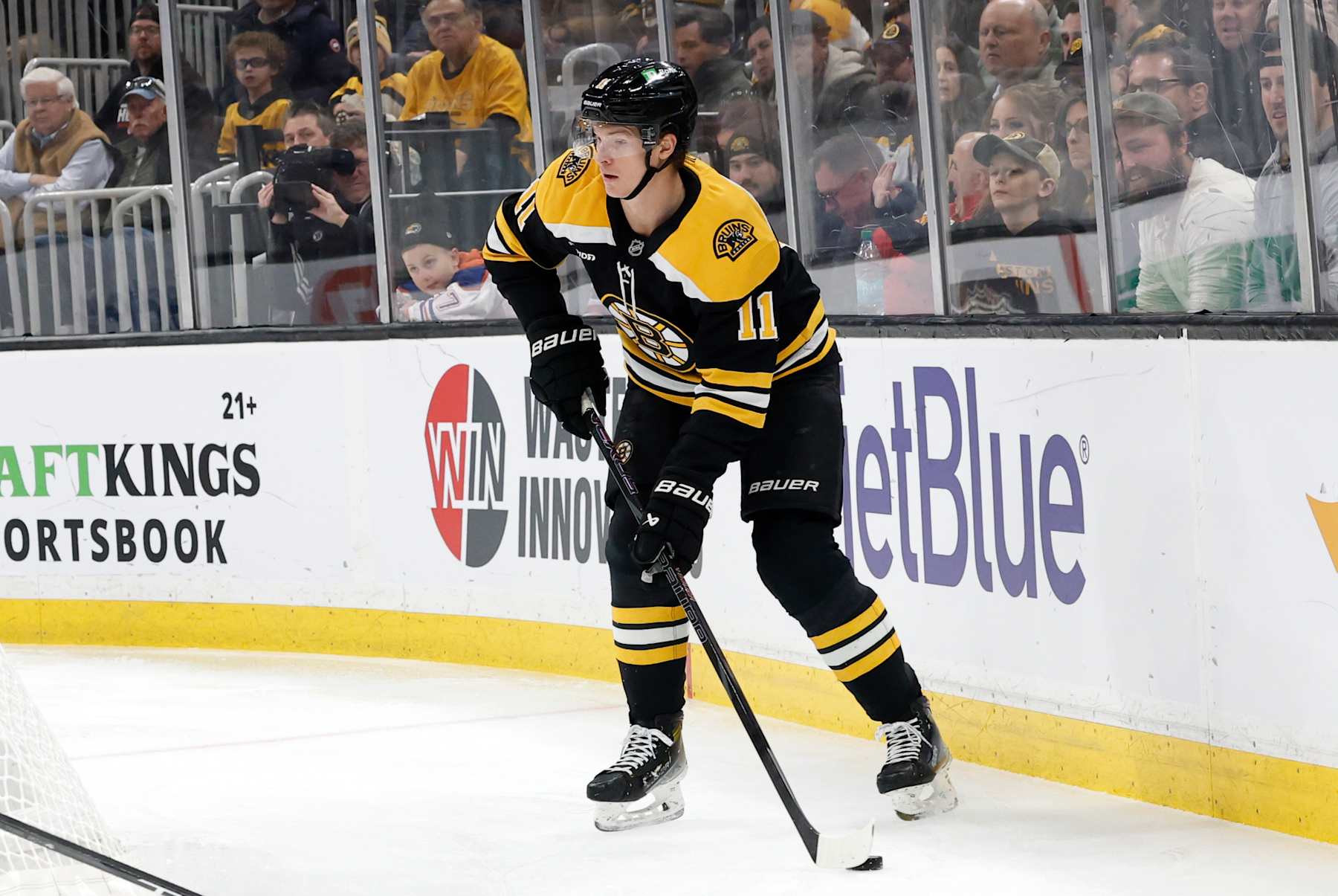 BOSTON, MA - JANUARY 07: Boston Bruins center Trent Frederic (11) holds the puck during a game between the Boston Bruins and the Edmonton Oilers on January 7, 2025, at TD garden in Boston, Massachusetts. (Photo by Fred Kfoury III/Icon Sportswire via Getty Images)