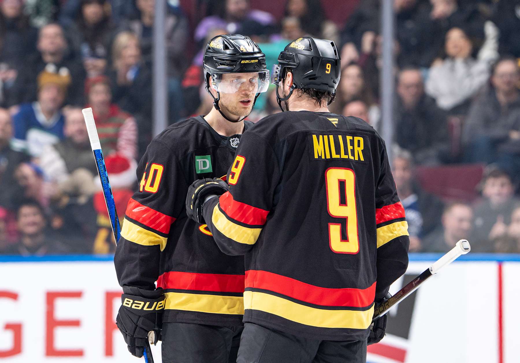 VANCOUVER, CANADA - DECEMBER 23: Elias Pettersson #40 and J.T. Miller #9 of the Vancouver Canucks discuss game play during the second period of their NHL game against the San Jose Sharks at Rogers Arena on December 23, 2024 in Vancouver, British Columbia, Canada. (Photo by Jeff Vinnick/NHLI via Getty Images)