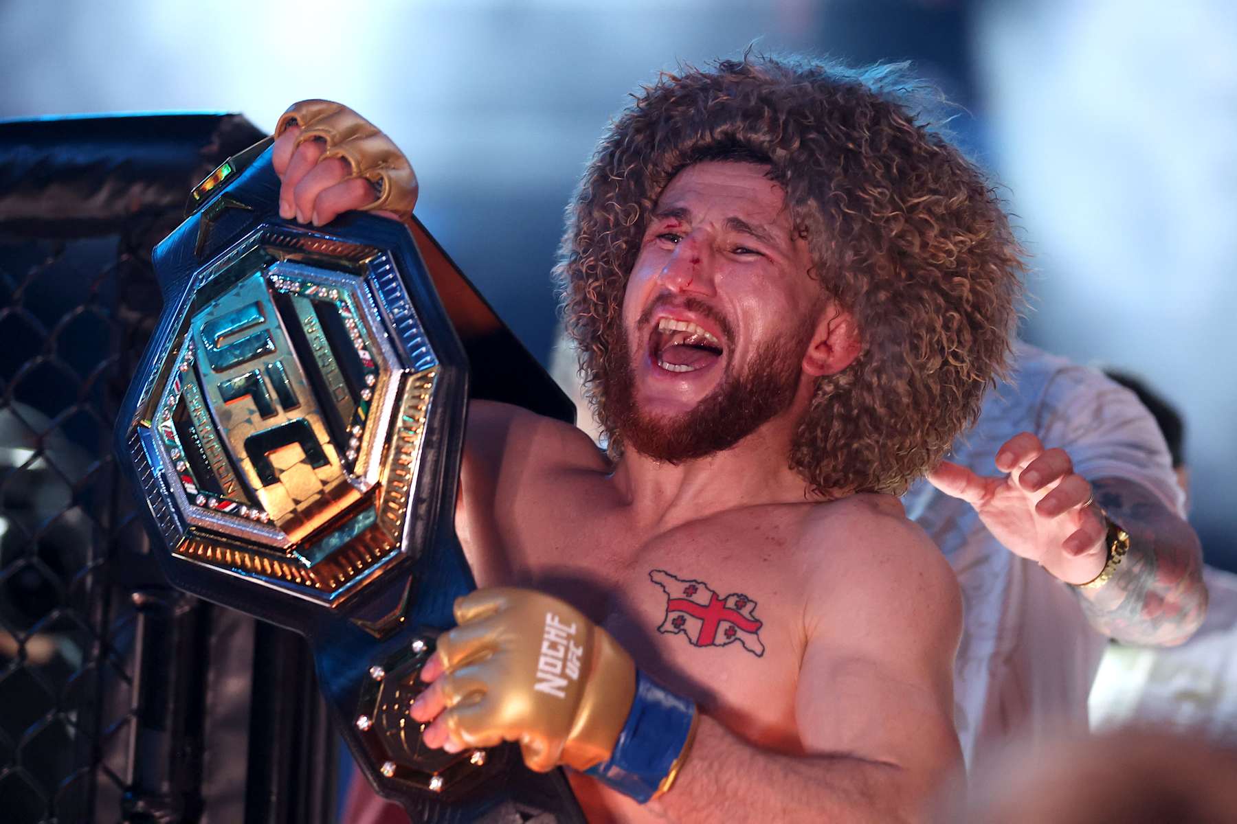 Merab Dvalishvili poses with the bantamweight title belt after defeating Sean O'Malley