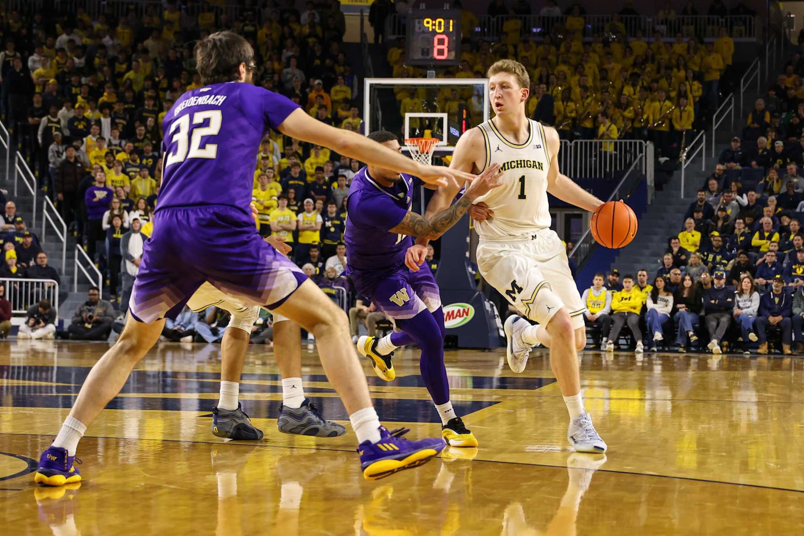 ANN ARBOR, MI - JANUARY 12:  Michigan Wolverines forward Danny Wolf (1) dribbles the ball against Washington defenders during the second half of a regular season Big Ten Conference college basketball game between the Washington Huskies and the Michigan Wolverines on January 12, 2025 at Crisler Center in Ann Arbor, Michigan.  (Photo by Scott W. Grau/Icon Sportswire via Getty Images)