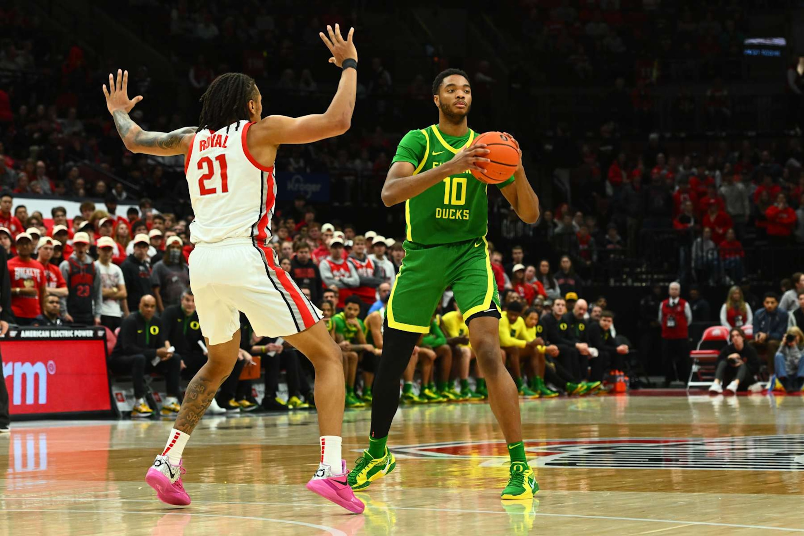 COLUMBUS, OHIO - JANUARY 9: Kwame Evans Jr. #10 of the Oregon Ducks controls the ball as Devin Royal #21 of the Ohio State Buckeyes defends during the first half of a game at Value City Arena on January 9, 2025 in Columbus, Ohio. (Photo by Ben Jackson/Getty Images)