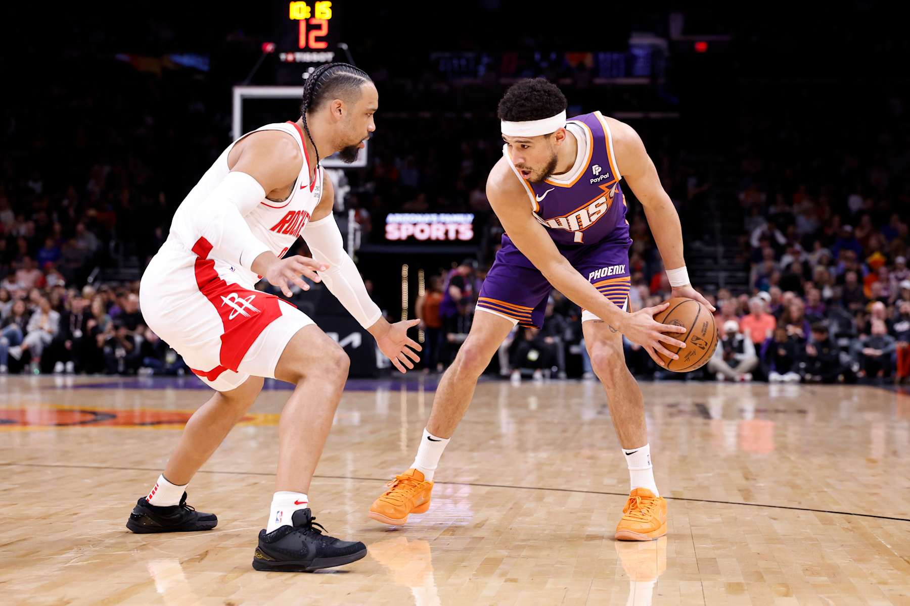 PHOENIX, ARIZONA - MARCH 02: Devin Booker #1 of the Phoenix Suns posts up on Dillon Brooks #9 of the Houston Rockets during the game at Footprint Center on March 02, 2024 in Phoenix, Arizona. The Rockets defeated the Suns 118-109. NOTE TO USER: User expressly acknowledges and agrees that, by downloading and or using this photograph, User is consenting to the terms and conditions of the Getty Images License Agreement.  (Photo by Chris Coduto/Getty Images)