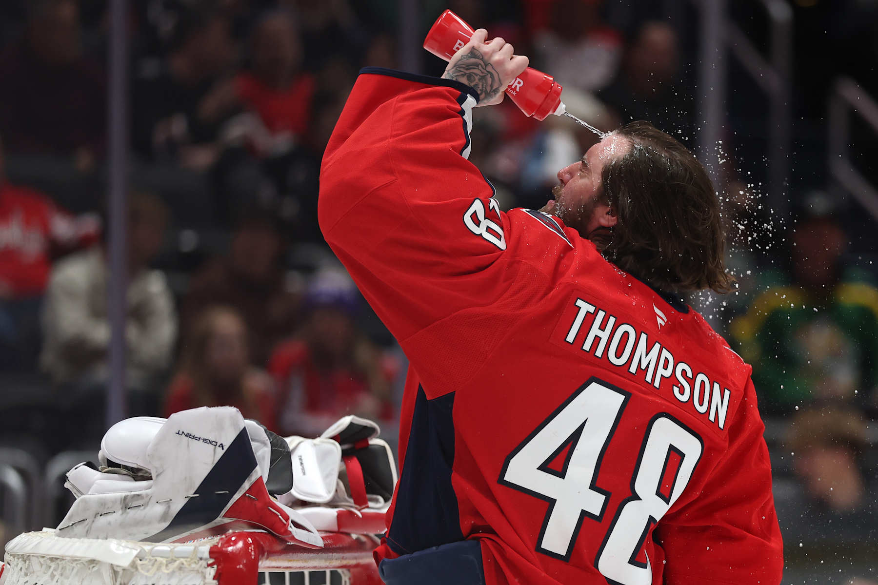 WASHINGTON, DC - JANUARY 14: Goalie Logan Thompson #48 of the Washington Capitals sprays water on his face before playing against the Anaheim Ducks during the first period at Capital One Arena on January 14, 2025 in Washington, DC. (Photo by Patrick Smith/Getty Images)