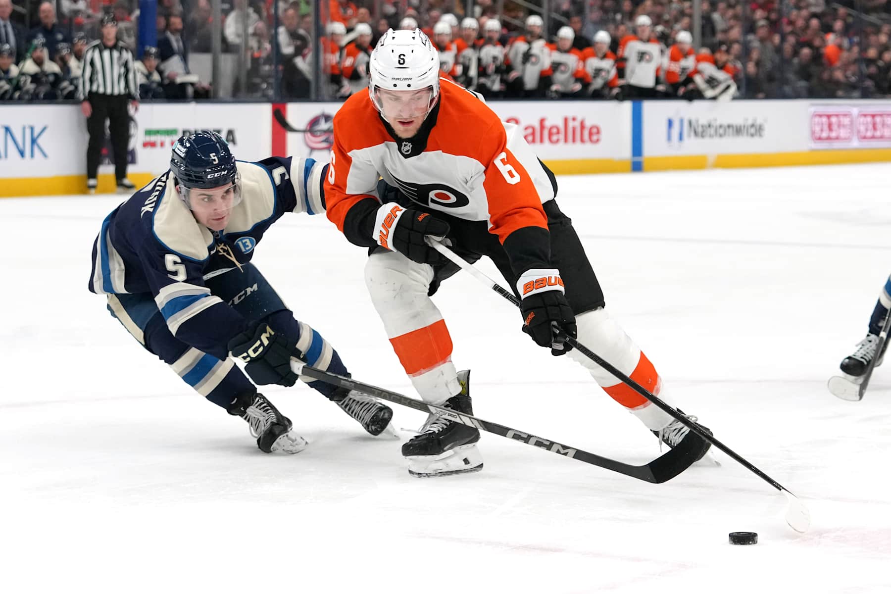 COLUMBUS, OHIO - JANUARY 14: Travis Sanheim #6 of the Philadelphia Flyers skates with the puck against Denton Mateychuk #5 of the Columbus Blue Jackets during the first period at Nationwide Arena on January 14, 2025 in Columbus, Ohio. (Photo by Jason Mowry/Getty Images)