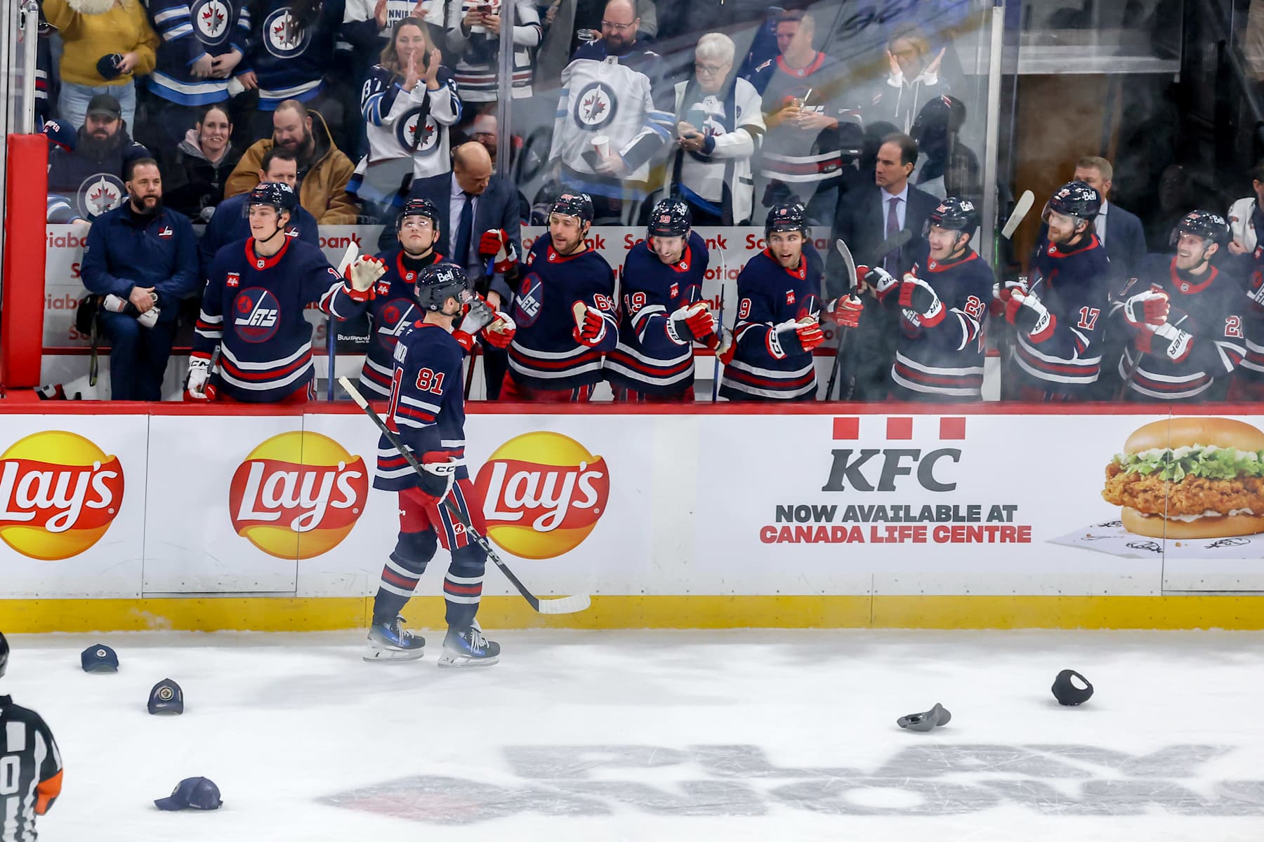 WINNIPEG, CANADA - JANUARY 14: Kyle Connor #81 of the Winnipeg Jets celebrate his first period hat trick goal against the Vancouver Canucks with teammates at the bench at the Canada Life Centre on January 14, 2025 in Winnipeg, Manitoba, Canada. (Photo by Jonathan Kozub/NHLI via Getty Images)