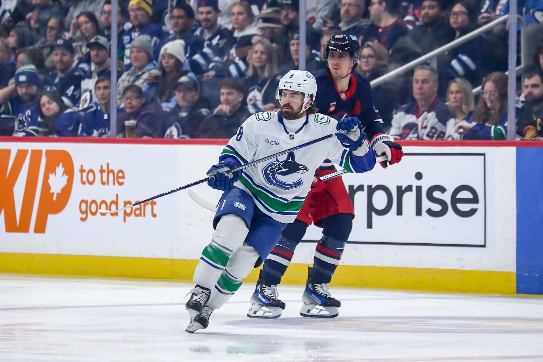 WINNIPEG, CANADA - JANUARY 14: Conor Garland #8 of the Vancouver Canucks and Mark Scheifele #55 of the Winnipeg Jets keep an eye on the play during first period action at the Canada Life Centre on January 14, 2025 in Winnipeg, Manitoba, Canada. (Photo by Darcy Finley/NHLI via Getty Images)