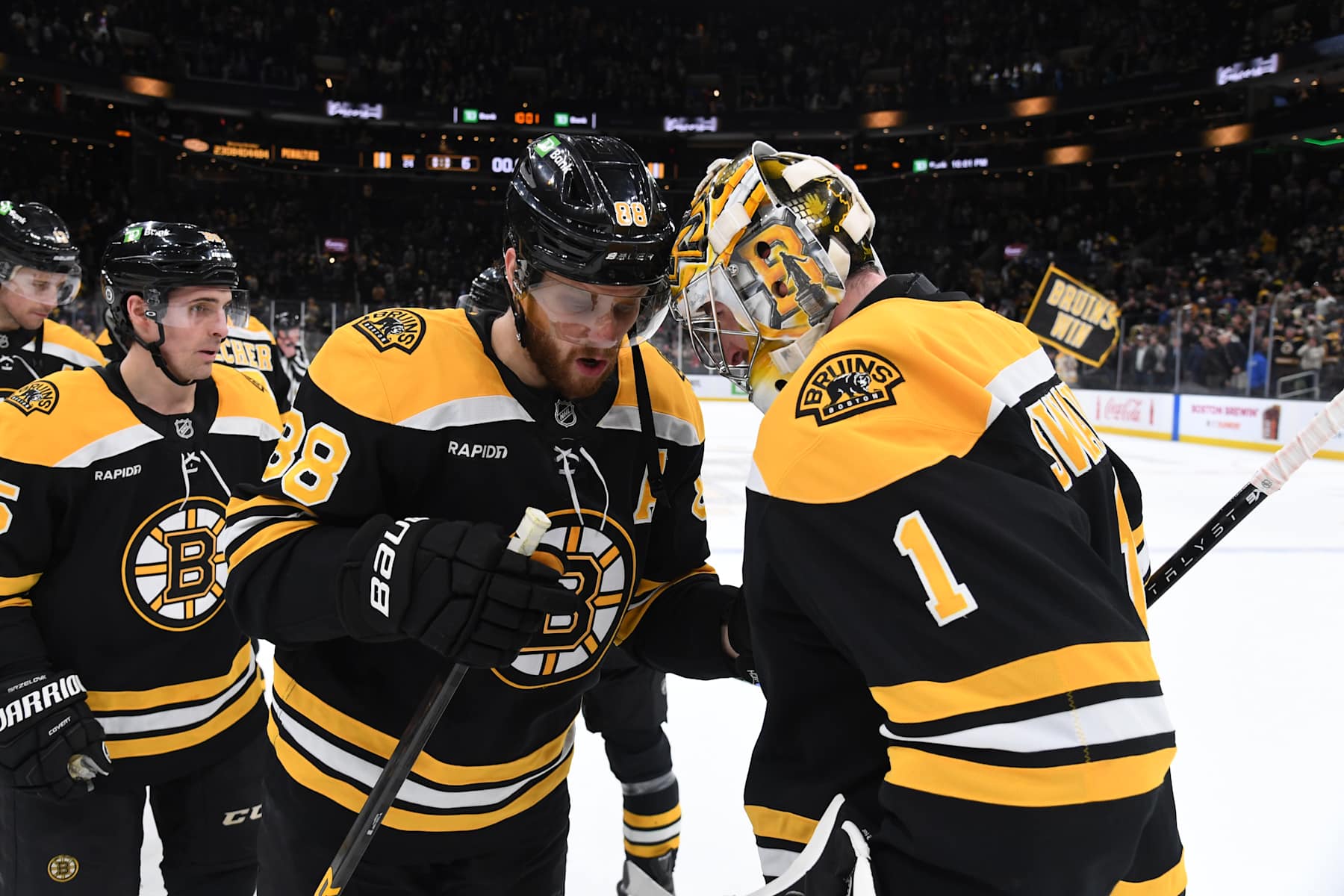 BOSTON, MASSACHUSETTS - JANUARY 14: David Pastrnak #88 and Jeremy Swayman #1 of the Boston Bruins celebrate the win against the Tampa Bay Lightning on January 14, 2025, at the TD Garden in Boston, Massachusetts. (Photo by Steve Babineau/NHLI via Getty Images)