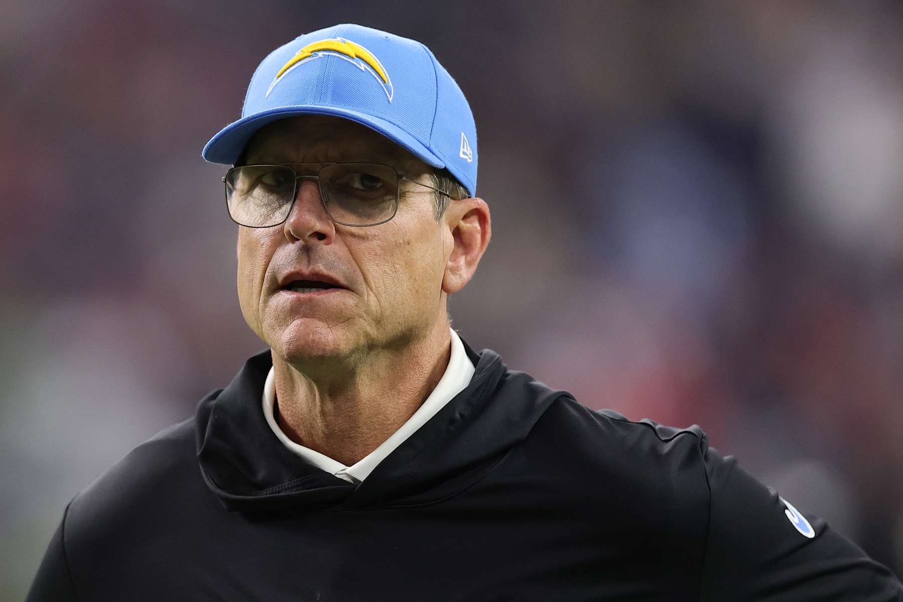 HOUSTON, TEXAS - JANUARY 11: Head coach Jim Harbaugh of the Los Angeles Chargers looks on at halftime against the Houston Texans during the AFC Wild Card Playoffs at NRG Stadium on January 11, 2025 in Houston, Texas. (Photo by Alex Slitz/Getty Images)