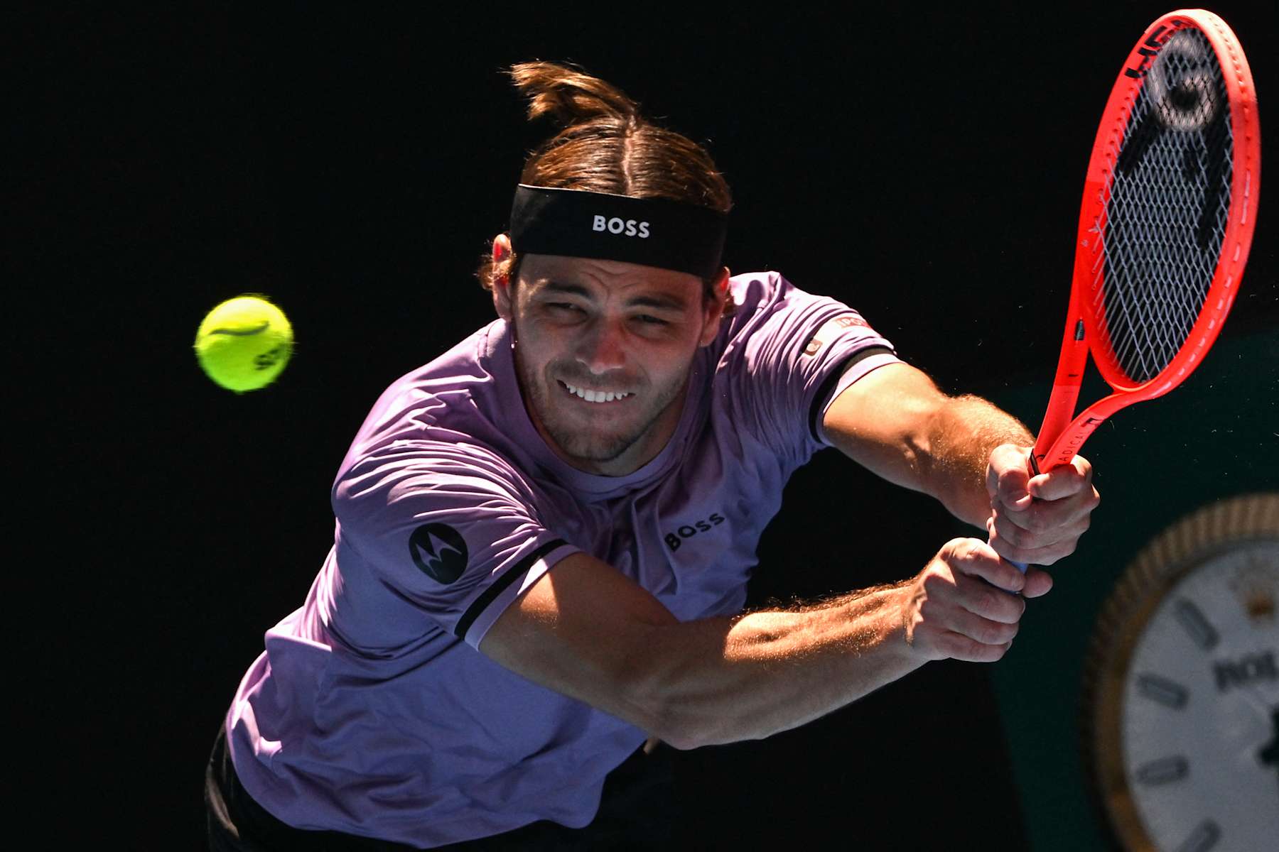 USA's Taylor Fritz hits a return against Chile's Cristian Garin during their men's singles match on day five of the Australian Open tennis tournament in Melbourne on January 16, 2025. (Photo by Paul Crock / AFP) / -- IMAGE RESTRICTED TO EDITORIAL USE - STRICTLY NO COMMERCIAL USE -- (Photo by PAUL CROCK/AFP via Getty Images)