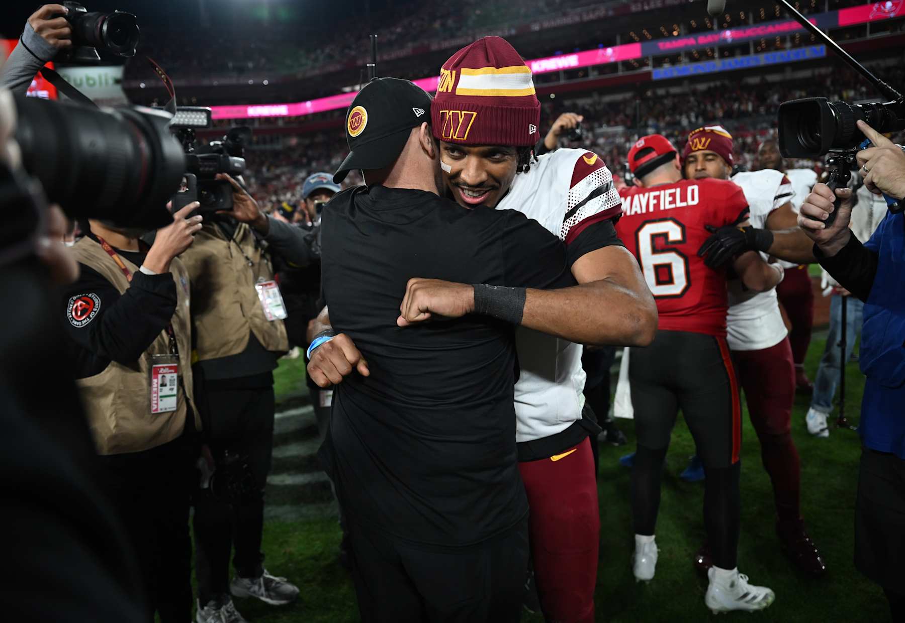 TAMPA, FL - January 12: Washington Commanders quarterback Jayden Daniels (5) hugs Washington Commanders head coach Dan Quinn after winning a wild card round playoff game between the Washington Commanders and the Tampa Bay Buccaneers on January 12, 2024 at Raymond James Stadium in Tampa, Fla. (Photo by Thomas Simonetti for The Washington Post via Getty Images)