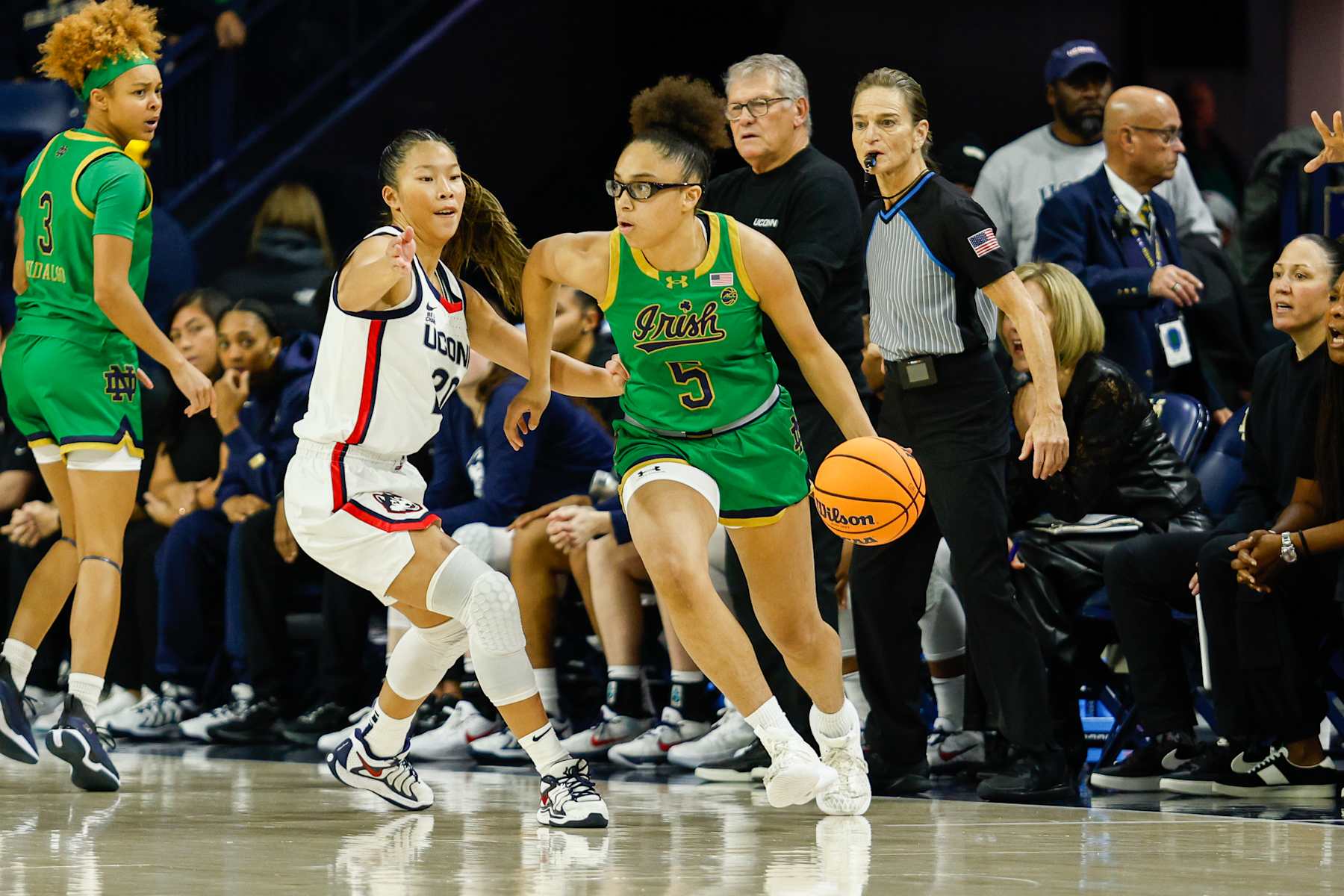 SOUTH BEND, IN - DECEMBER 12: Olivia Miles #5 of Notre Dame dribbles around Kaityln Chen #20 of UConn during a game between Connecticut and Notre Dame at Purcell Pavillion at the Joyce Center on December 12, 2024 in South Bend, Indiana. (Photo by Michael Miller/ISI Photos/Getty Images)