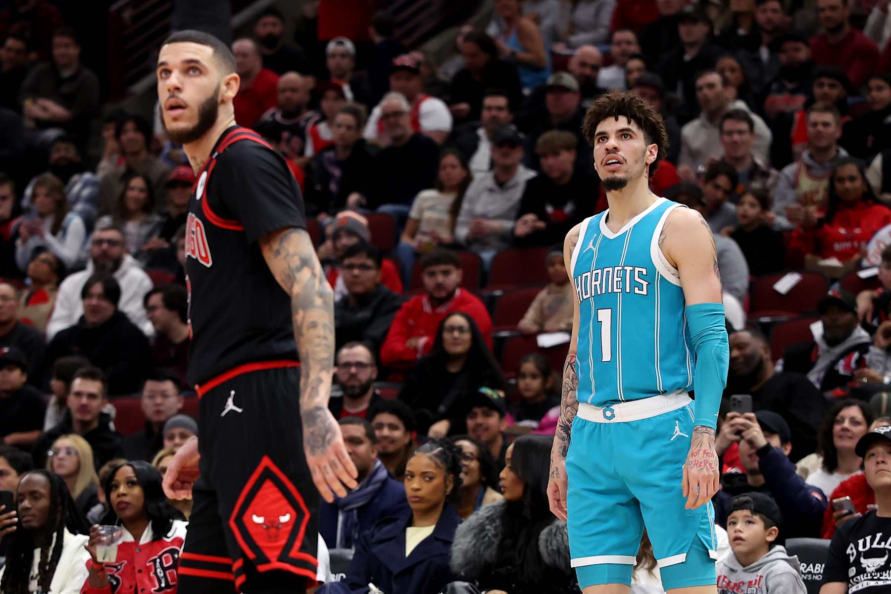 CHICAGO, ILLINOIS - JANUARY 17: (L-R) Lonzo Ball #2 of the Chicago Bulls and LaMelo Ball #1 of the Charlotte Hornets look on during the second quarter at the United Center on January 17, 2025 in Chicago, Illinois. NOTE TO USER: User expressly acknowledges and agrees that, by downloading and or using this photograph, user is consenting to the terms and conditions of the Getty Images License Agreement. (Photo by Luke Hales/Getty Images)