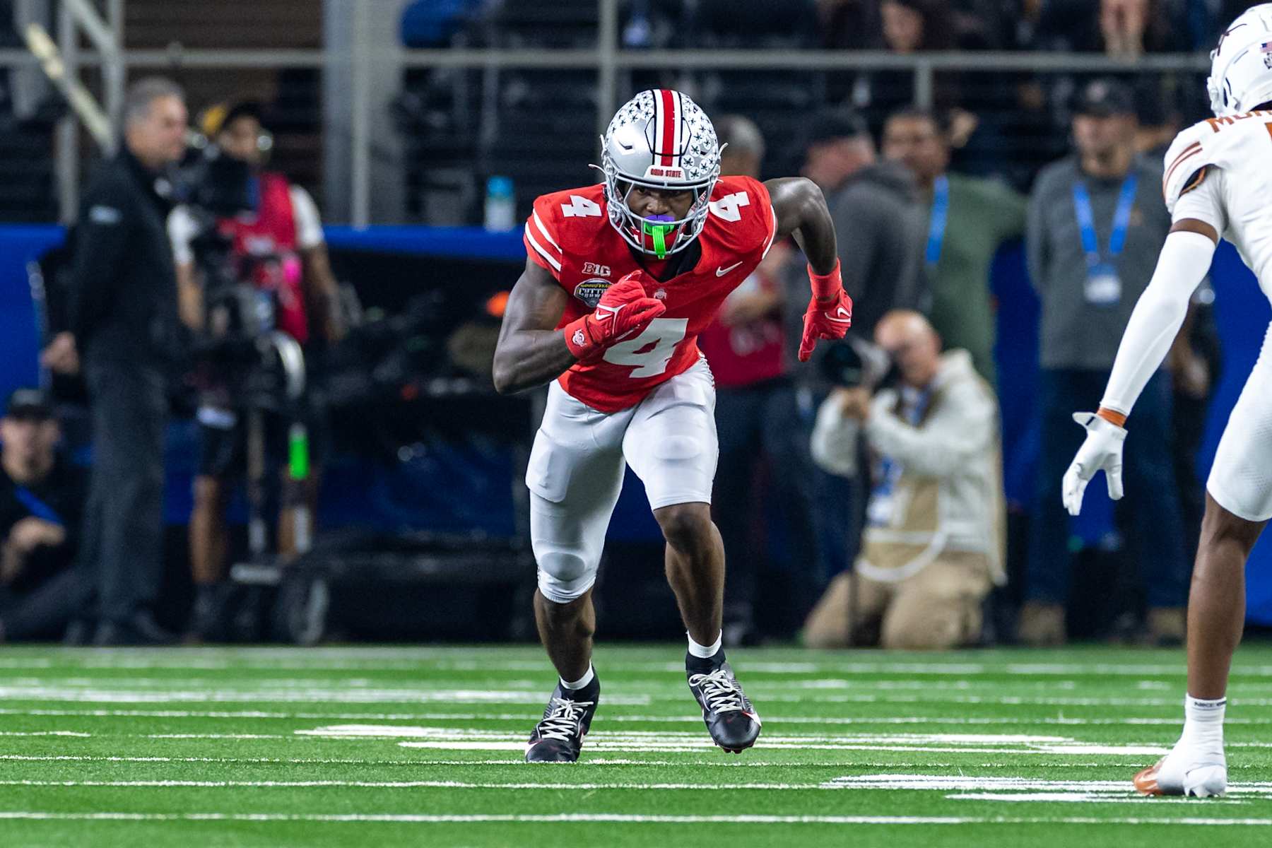 ARLINGTON, TX - JANUARY 10: Ohio State Buckeyes wide receiver Jeremiah Smith (#4) runs up field during the CFP Semifinal Cotton Bowl Classic football game between the Ohio State Buckeyes and Texas Longhorns on January 10, 2025 at AT&T Stadium in Arlington, TX.  (Photo by Matthew Visinsky/Icon Sportswire via Getty Images)