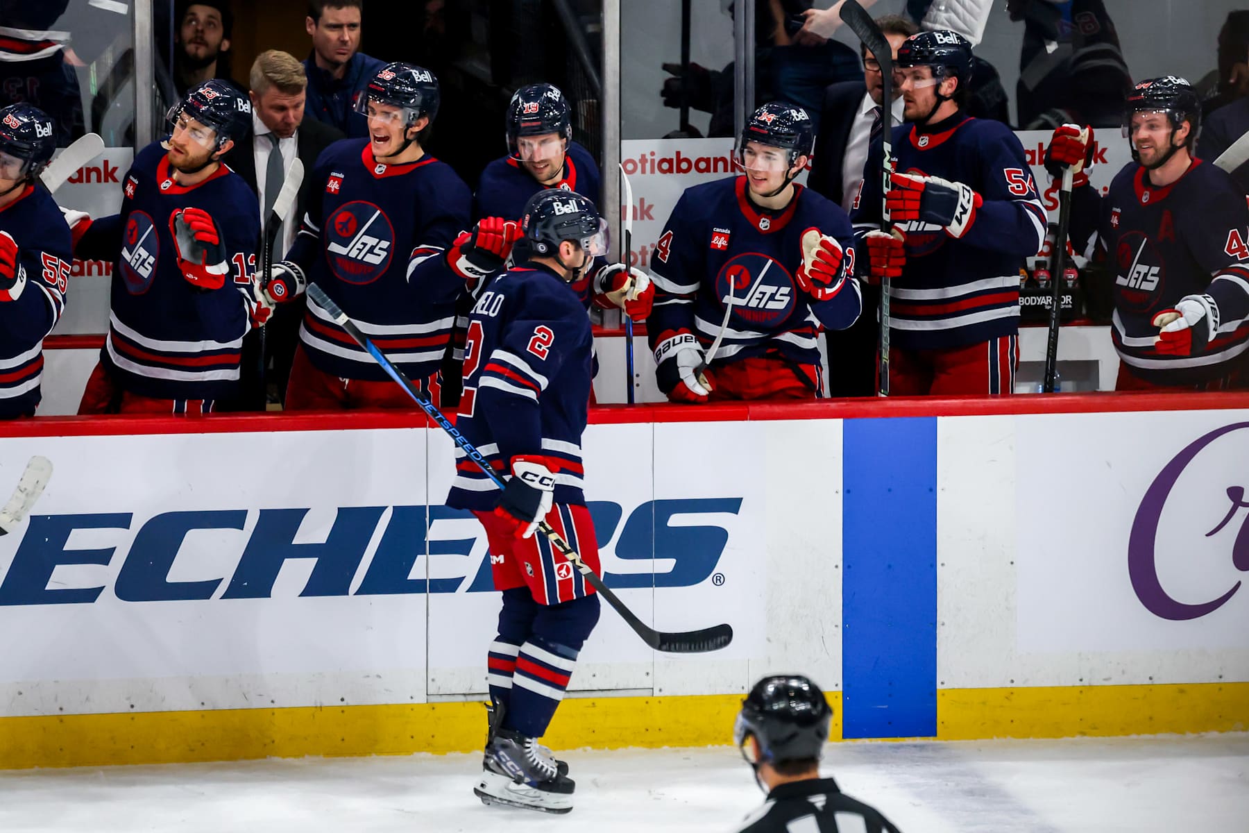 WINNIPEG, CANADA - JANUARY 16: Dylan DeMelo #2 of the Winnipeg Jets celebrates his third period goal against the Seattle Kraken with teammates at the bench at the Canada Life Centre on January 16, 2025 in Winnipeg, Manitoba, Canada. (Photo by Jonathan Kozub/NHLI via Getty Images)