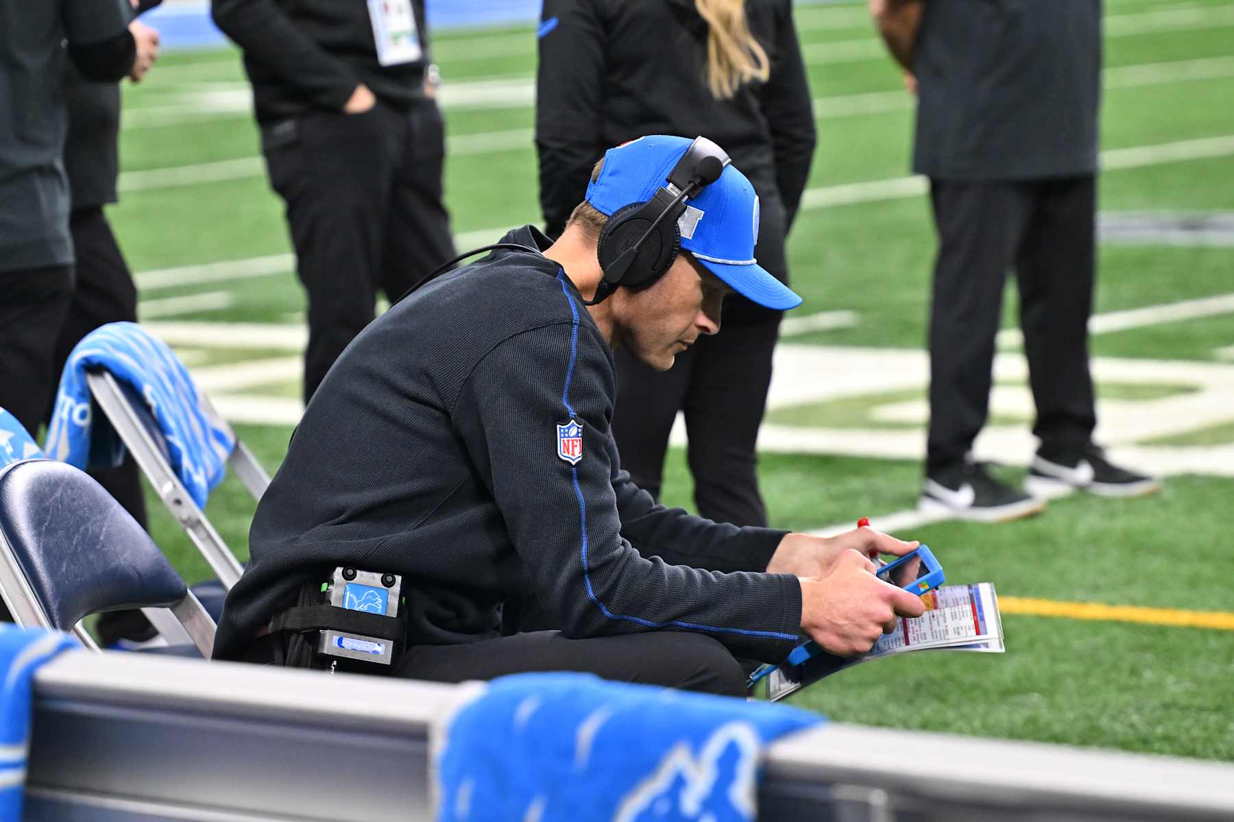 DETROIT, MI - JANUARY 18: Detroit Lions offensive coordinator Ben Johnson sits on the sidelines looking at replays during the NFC Divisional Playoff game between the Detroit Lions and the Washington Commanders on Sunday January 18, 2025 at Ford Field in Detroit, MI. (Photo by Steven King/Icon Sportswire via Getty Images)