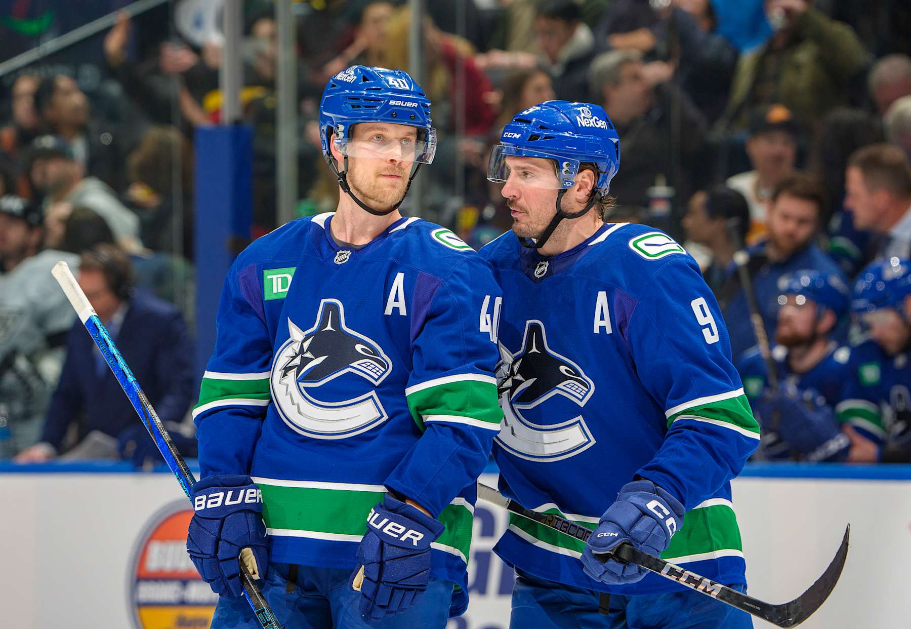 VANCOUVER, CANADA - JANUARY 16: J.T. Miller #9 and Elias Pettersson #40 of the Vancouver Canucks discuss game play during the second period of their NHL game against the Los Angeles Kings at Rogers Arena on January 16, 2025 in Vancouver, British Columbia, Canada. (Photo by Jeff Vinnick/NHLI via Getty Images)