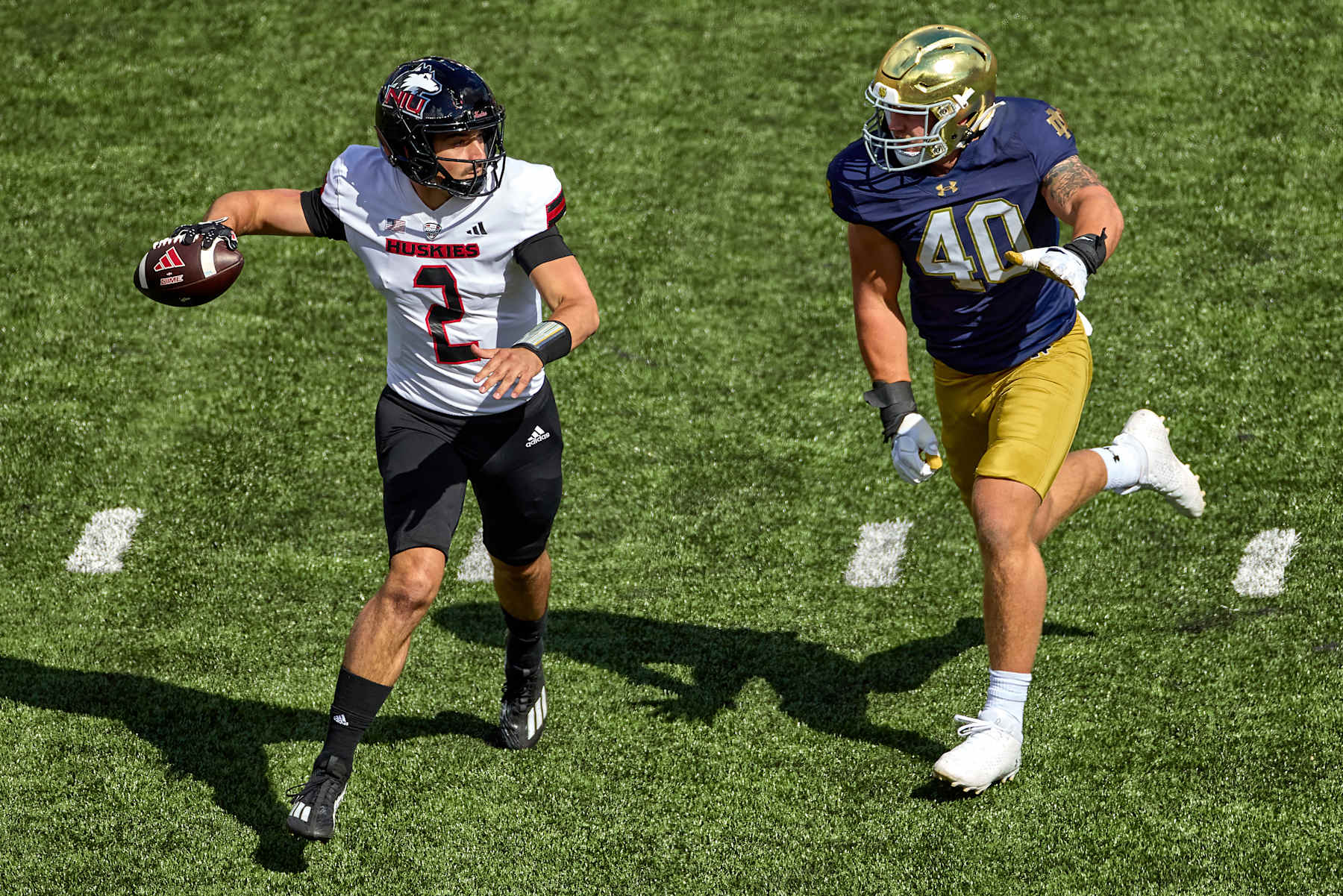 SOUTH BEND, IN - SEPTEMBER 07: Northern Illinois Huskies quarterback Ethan Hampton (2) runs with the football and battles with Notre Dame Fighting Irish linebacker Joshua Burnham (40) in action during a game between the Northern Illinois Huskies the Notre Dame Fighting Irish on September 7, 2024, at Notre Dame Stadium in South Bend, IN. (Photo by Robin Alam/Icon Sportswire via Getty Images)