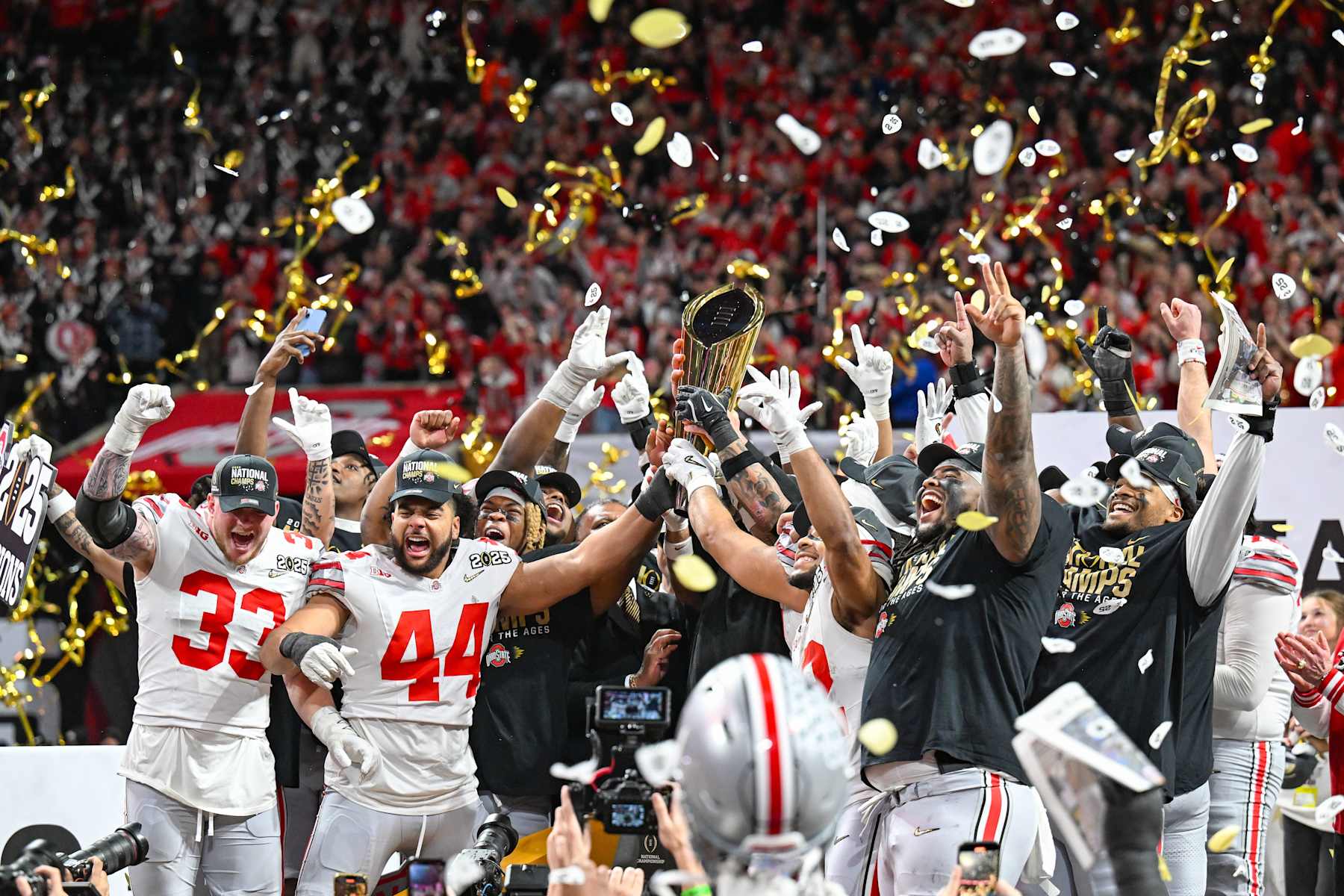 ATLANTA, GA  JANUARY 20:  Ohio State players celebrate with the winning trophy following the conclusion of the the Ohio State Buckeyes versus Notre Dame Fighting Irish College Football Playoff National Championship game on January 20, 2025, at Mercedes-Benz Stadium in Atlanta, GA.  (Photo by Rich von Biberstein/Icon Sportswire via Getty Images)