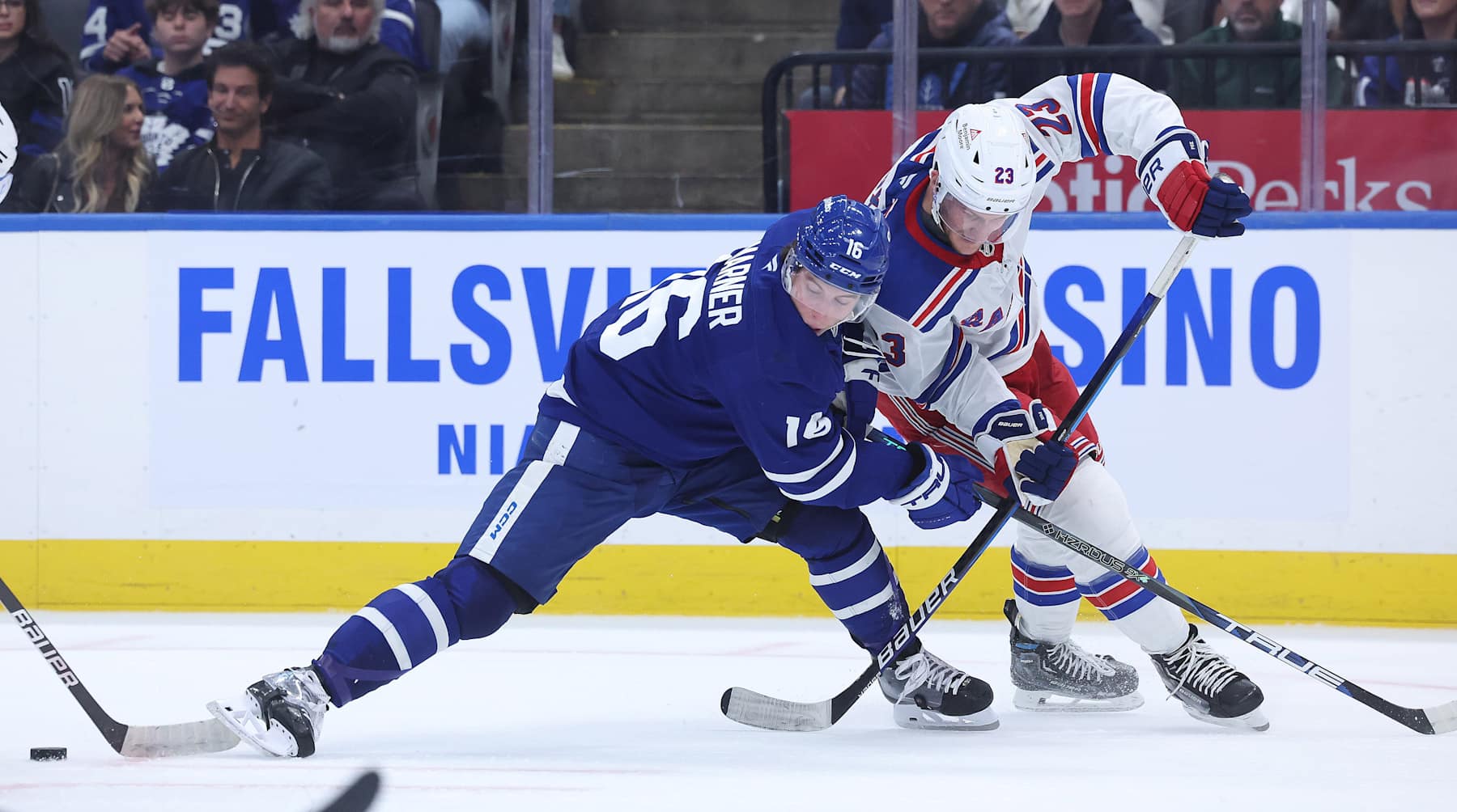 TORONTO, ON - OCTOBER 19 - Toronto Maple Leafs right wing Mitch Marner (16) tries to get to a puck as he battles New York Rangers defenseman Adam Fox (23) in third period action as the Toronto Maple Leafs fall to the New York Rangers 4-1 at Scotiabank Arena in Toronto. October 19, 2024. (Photo by Steve Russell/Toronto Star via Getty Images)