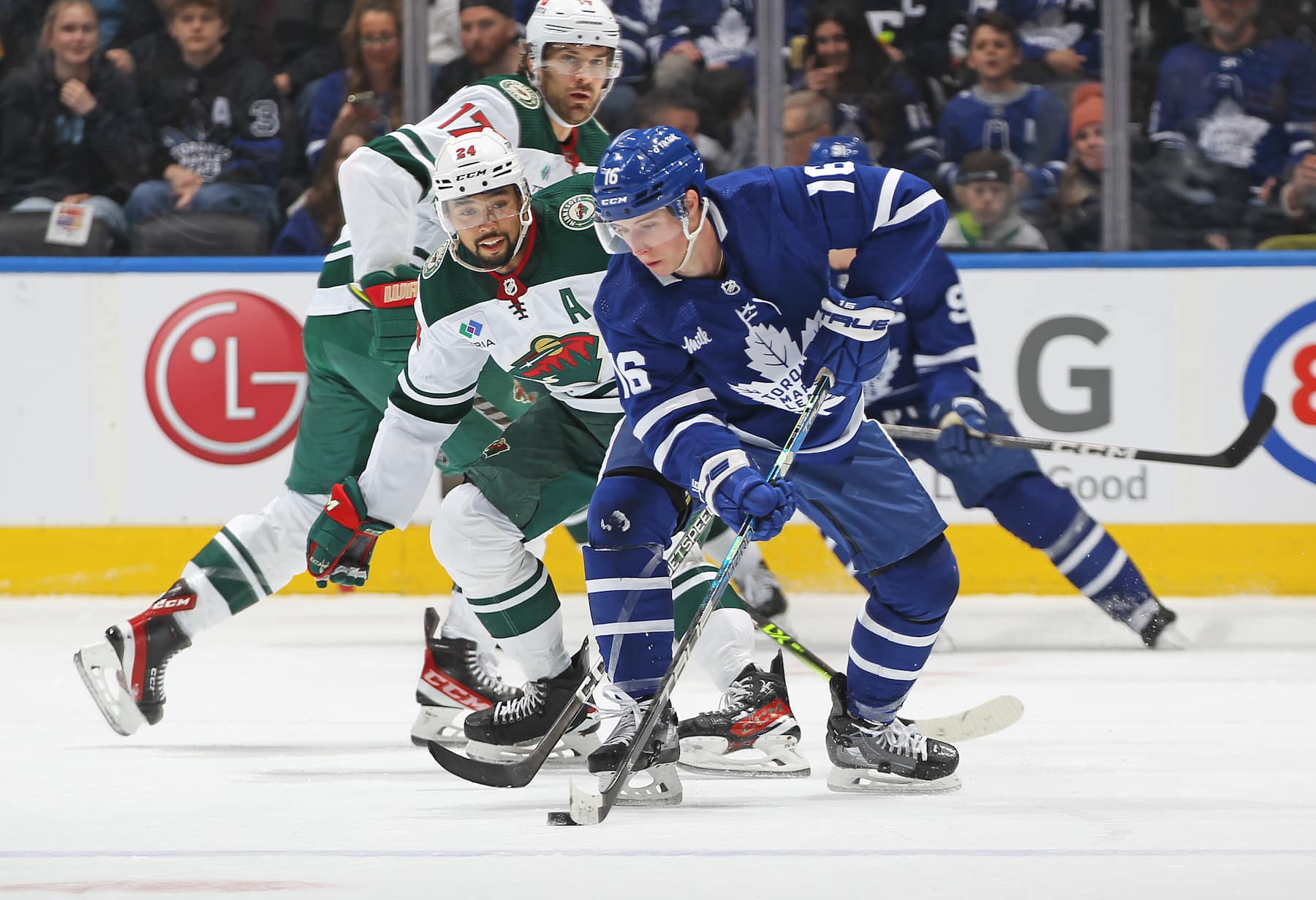 TORONTO, CANADA - FEBRUARY 24: Matt Dumba #24 of the Minnesota Wild tries to contain Mitchell Marner #16 of the Toronto Maple Leafs during an NHL game at Scotiabank Arena on February 24, 2023 in Toronto, Ontario, Canada. (Photo by Claus Andersen/Getty images)