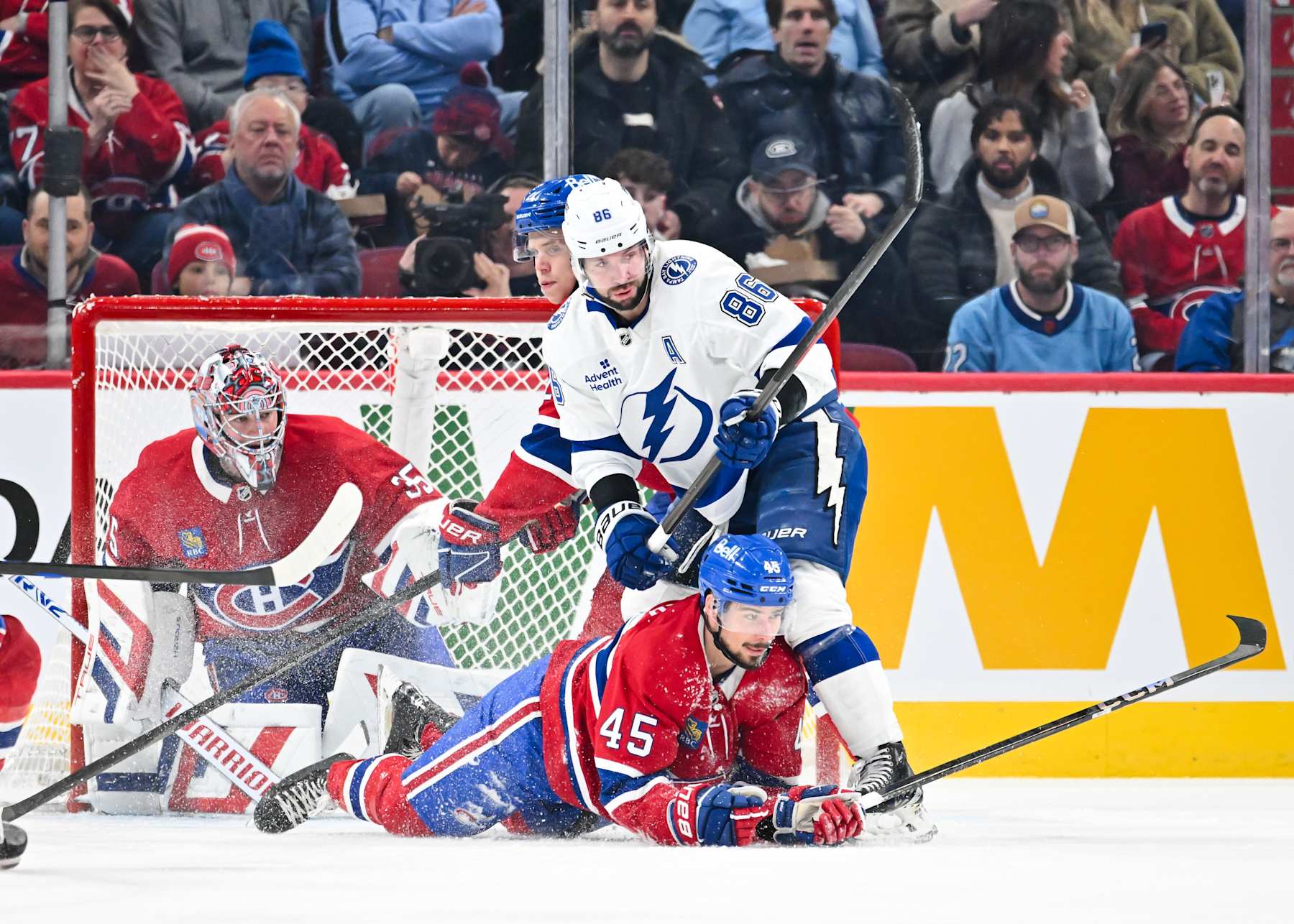 MONTREAL, CANADA - JANUARY 21: Nikita Kucherov #86 of the Tampa Bay Lightning holds down Alexandre Carrier #45 of the Montreal Canadiens during the second period at the Bell Centre on January 21, 2025 in Montreal, Quebec, Canada. (Photo by Minas Panagiotakis/Getty Images)