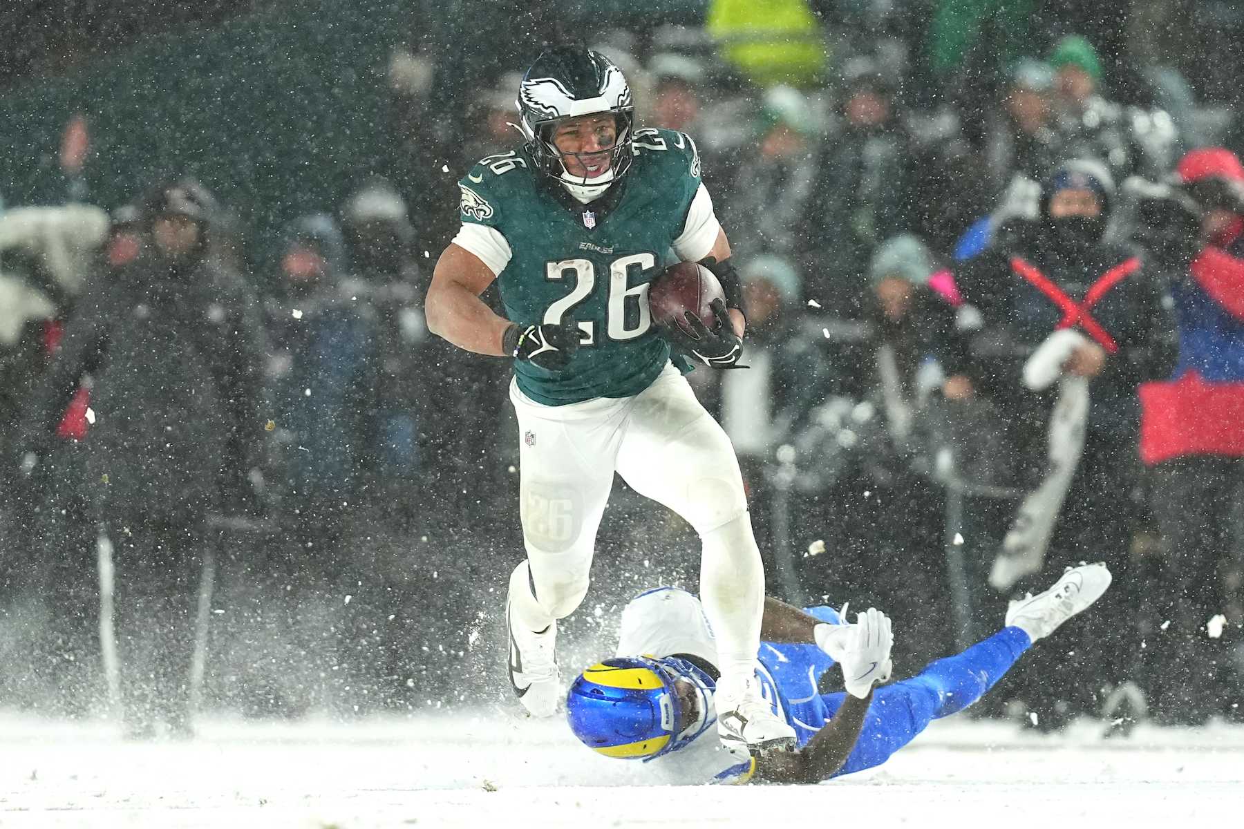 PHILADELPHIA, PENNSYLVANIA - JANUARY 19: Saquon Barkley #26 of the Philadelphia Eagles runs the ball for a 78-yard touchdown against the Los Angeles Rams during the fourth quarter in the NFC Divisional Playoff at Lincoln Financial Field on January 19, 2025 in Philadelphia, Pennsylvania. (Photo by Mitchell Leff/Getty Images)