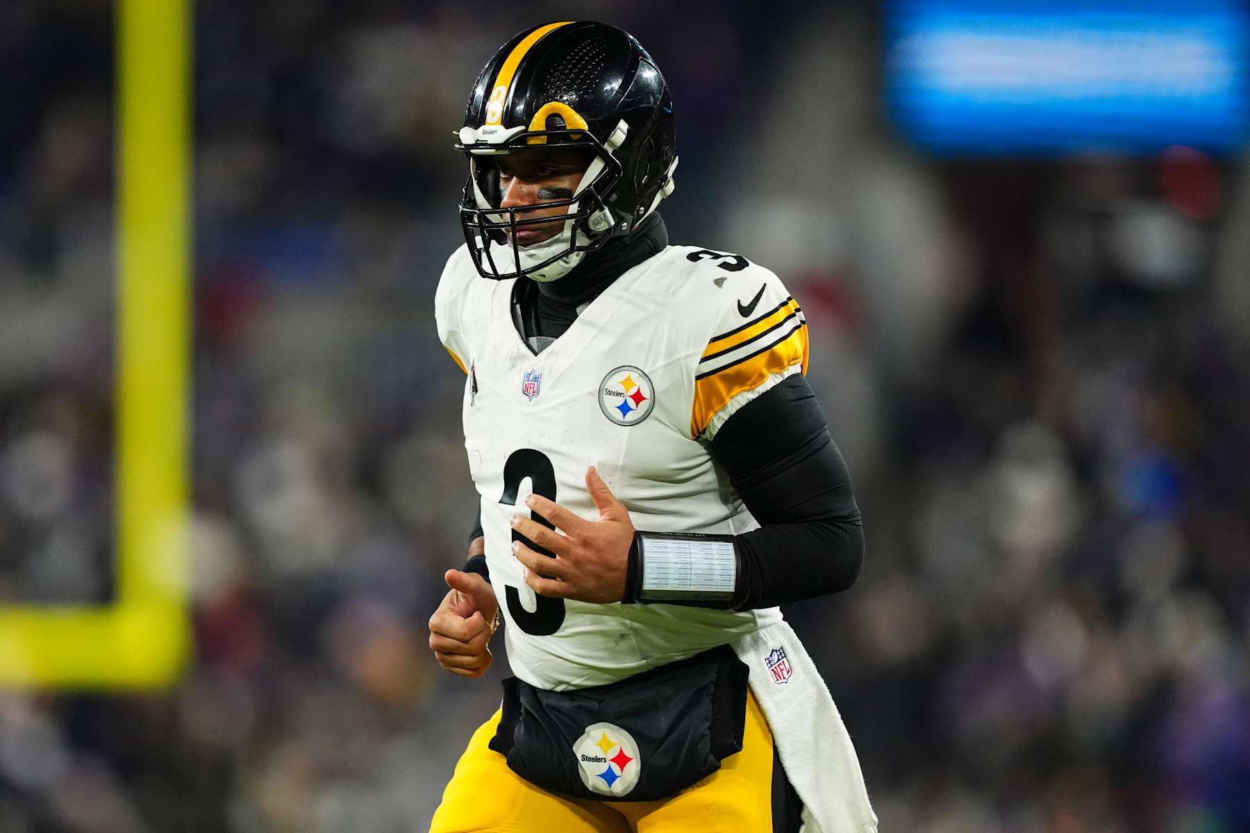 BALTIMORE, MD - JANUARY 11: Russell Wilson #3 of the Pittsburgh Steelers runs across the field during an NFL football wild card playoff game against the Baltimore Ravens at M&T Bank Stadium on January 11, 2025 in Baltimore, Maryland. (Photo by Cooper Neill/Getty Images)