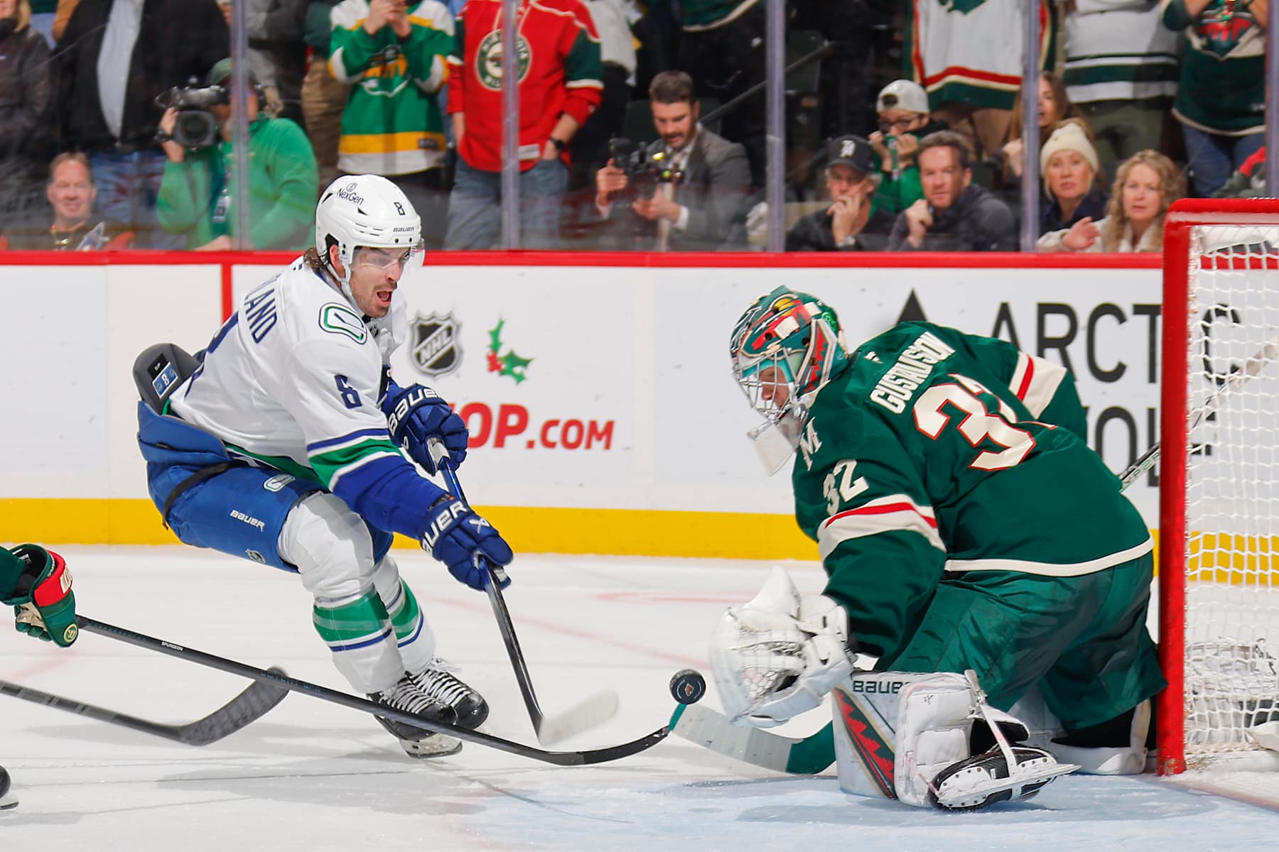 SAINT PAUL, MN - DECEMBER 3: Filip Gustavsson #32 of the Minnesota Wild makes a save against Brock Boeser #6 of the Vancouver Canucks during the game at the Xcel Energy Center on December 3, 2024 in Saint Paul, Minnesota. (Photo by Bruce Kluckhohn/NHLI via Getty Images)