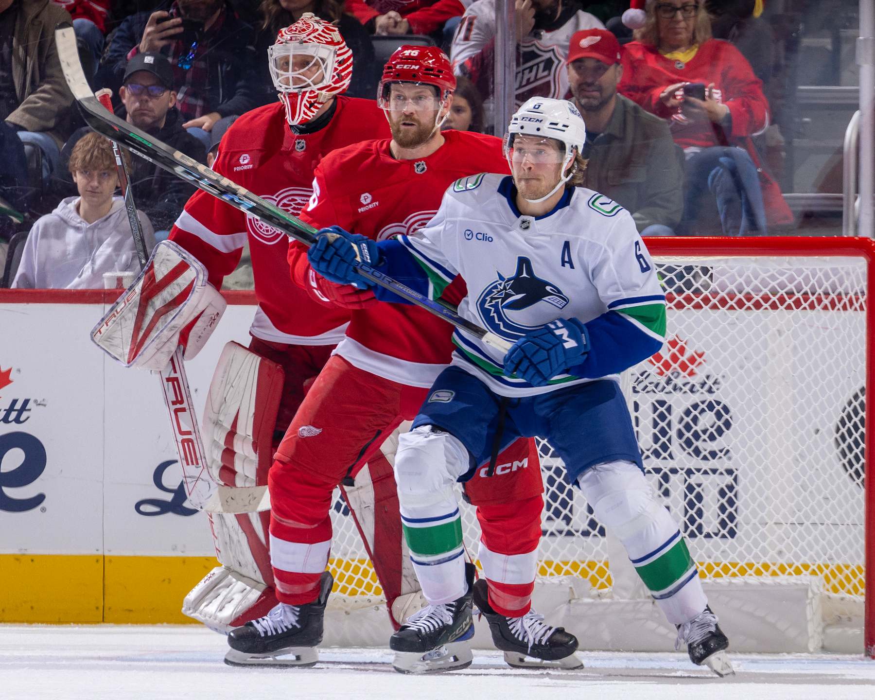 DETROIT, MICHIGAN - DECEMBER 01: Ville Husso #35 of the Detroit Red Wings follows the play as Jeff Petry #46 defends against Brock Boeser #6 of the Vancouver Canucks during the third period at Little Caesars Arena on December 1, 2024 in Detroit, Michigan. Vancouver defeated Detroit 5-4 in O.T. (Photo by Dave Reginek/NHLI via Getty Images)