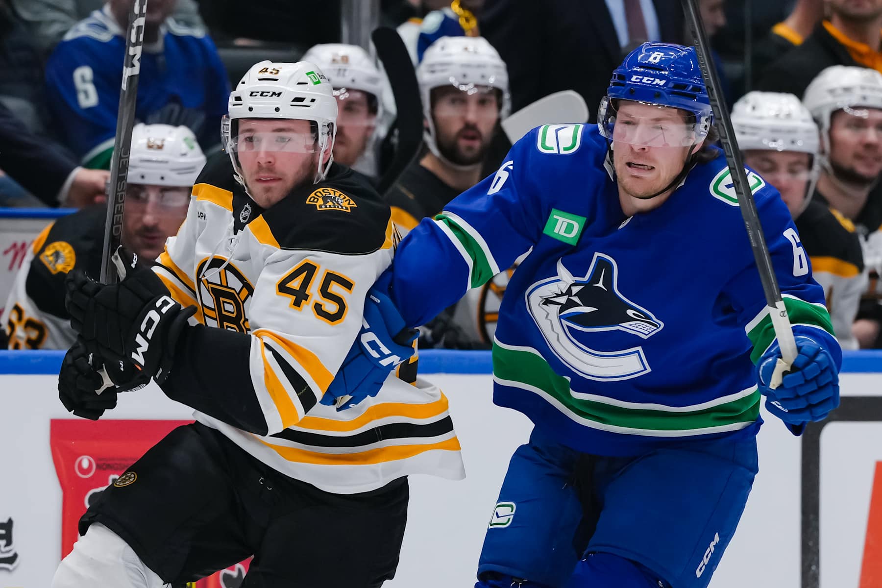 VANCOUVER, CANADA - DECEMBER 14: Cole Koepke #45 of the Boston Bruins and Brock Boeser #6 of the Vancouver Canucks skate during the second period of their NHL game at Rogers Arena on December 14, 2024 in Vancouver, British Columbia, Canada. (Photo by Derek Cain/Getty Images)