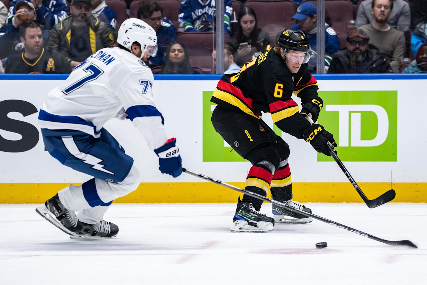 VANCOUVER, BC - DECEMBER 08: Vancouver Canucks right wing Brock Boeser (6) and Tampa Bay Lightning defenseman Victor Hedman (77) vie for the puck during the first period of an NHL game between the Tampa Bay Lightning and the Vancouver Canucks on Sunday, December 8, 2024 at Rogers Arena in Vancouver, B.C. (Photo by Ethan Cairns/Icon Sportswire via Getty Images)